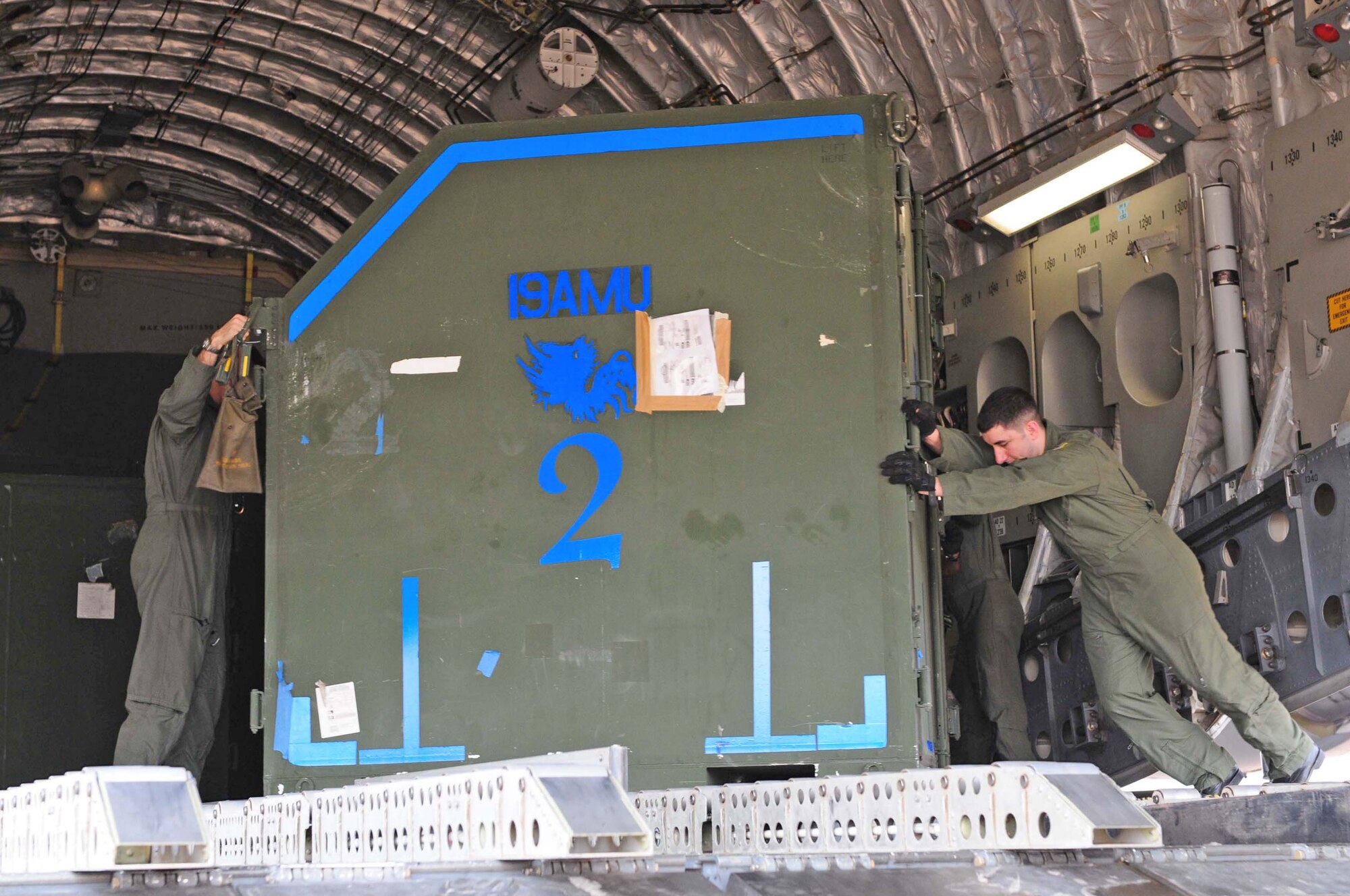 Senior Airman David Russell (right) removes cargo from a C-17 Globemaster III for Exercise Cope Tiger 2010 Feb. 28, 2010, at Udon Thani Royal Thai Air Force Base, Thailand. Cope Tiger is an annual multilateral exercise involving the United States, Thailand and Singapore. Airman Russell is deployed to Udon Thani from Elmendorf Air Force Base, Alaska. (U.S. Air Force photo/Capt. Genieve David)