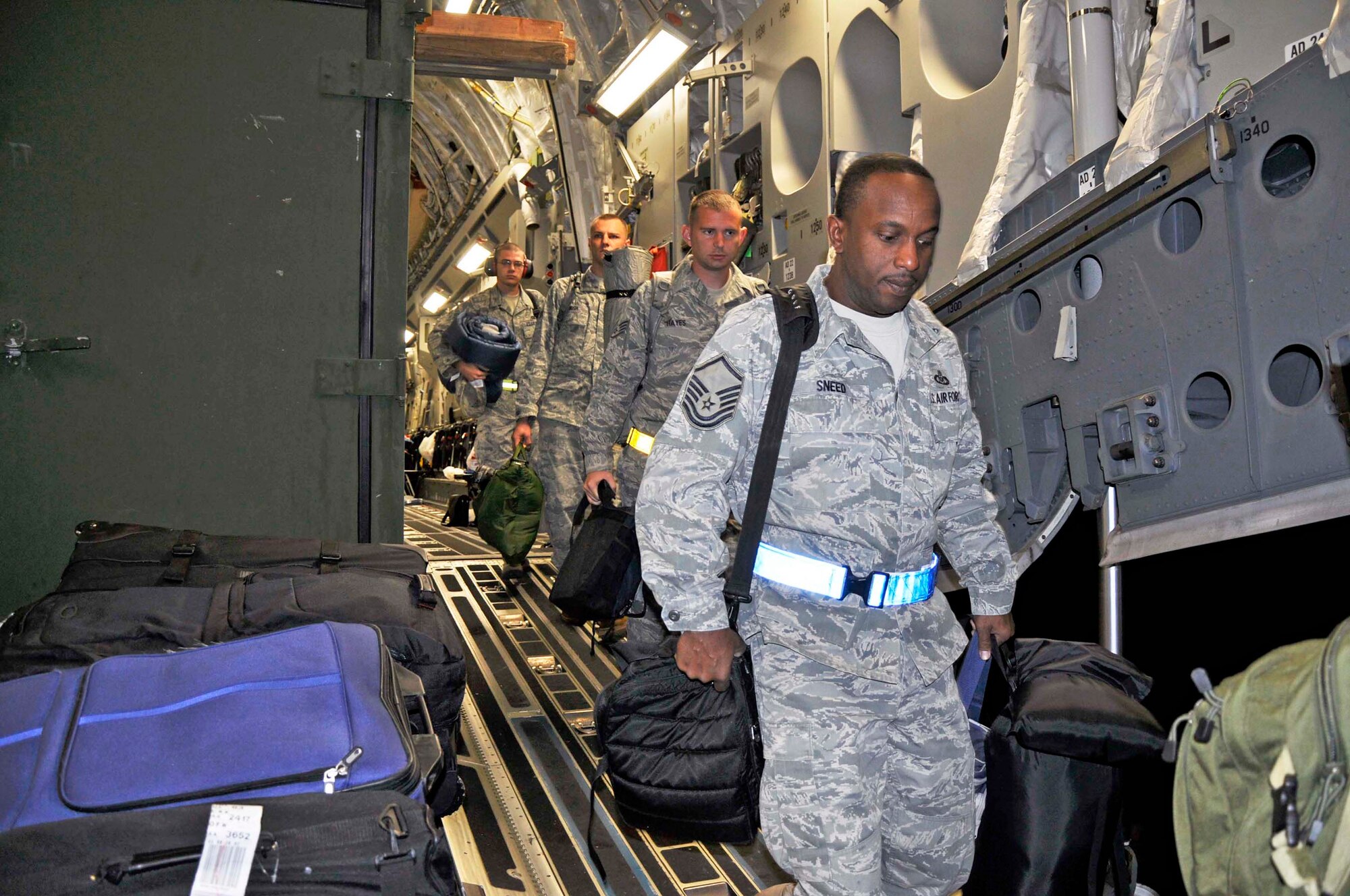 Master Sgt. Ray Sneed disembarks a C-17 Globemaster III Feb. 26, 2010, at Udon Thani Royal Thai Air Force Base, Thailand. Sergeant Sneed, from the 15th Operations Support Squadron at Joint Base Pearl Harbor-Hickam, Hawaii, is one of approximately 500 Airmen who will participate in Cope Tiger 2010, an annual training exercise in Thailand involving the U.S. Air Force, Royal Thai Air Force and Army, and the Republic of Singapore Air Force March 1-12. (U.S. Air Force photo/Capt. Christy Stravolo)