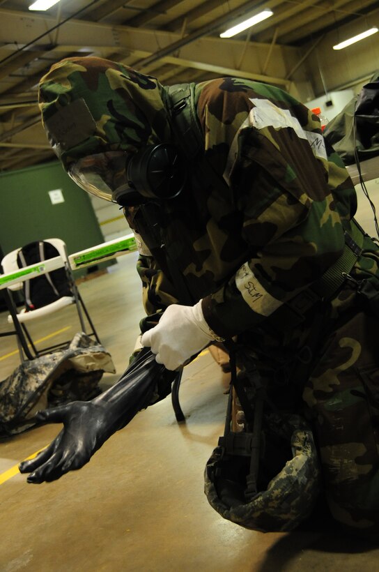 ELLSWORTH AIR FORCE BASE, S.D. -- Senior Airman Adam Winston, 28th Logistics Readiness Squadron maintenance supply liaison, put on his chemical and biological warfare gear during a Phase II Operational Readiness Exercise, March 2.  The Phase II ORE is designed to simulate a deployed environment and test the combat abilities of Ellsworth's Airmen. (U.S. Air Force photo/Airman 1st Class Anthony Sanchelli)