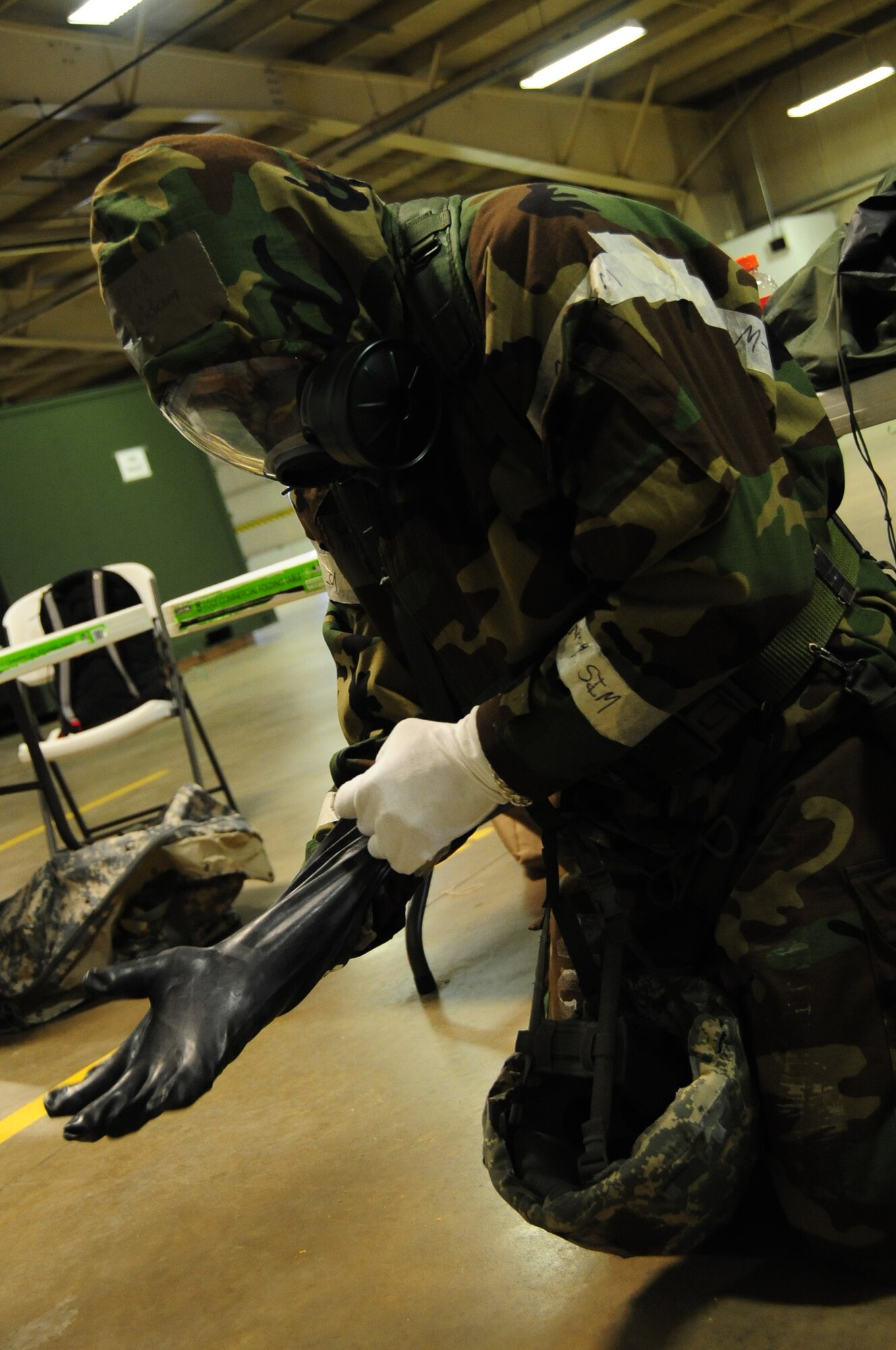 ELLSWORTH AIR FORCE BASE, S.D. -- Senior Airman Adam Winston, 28th Logistics Readiness Squadron maintenance supply liaison, put on his chemical and biological warfare gear during a Phase II Operational Readiness Exercise, March 2.  The Phase II ORE is designed to simulate a deployed environment and test the combat abilities of Ellsworth's Airmen. (U.S. Air Force photo/Airman 1st Class Anthony Sanchelli)
