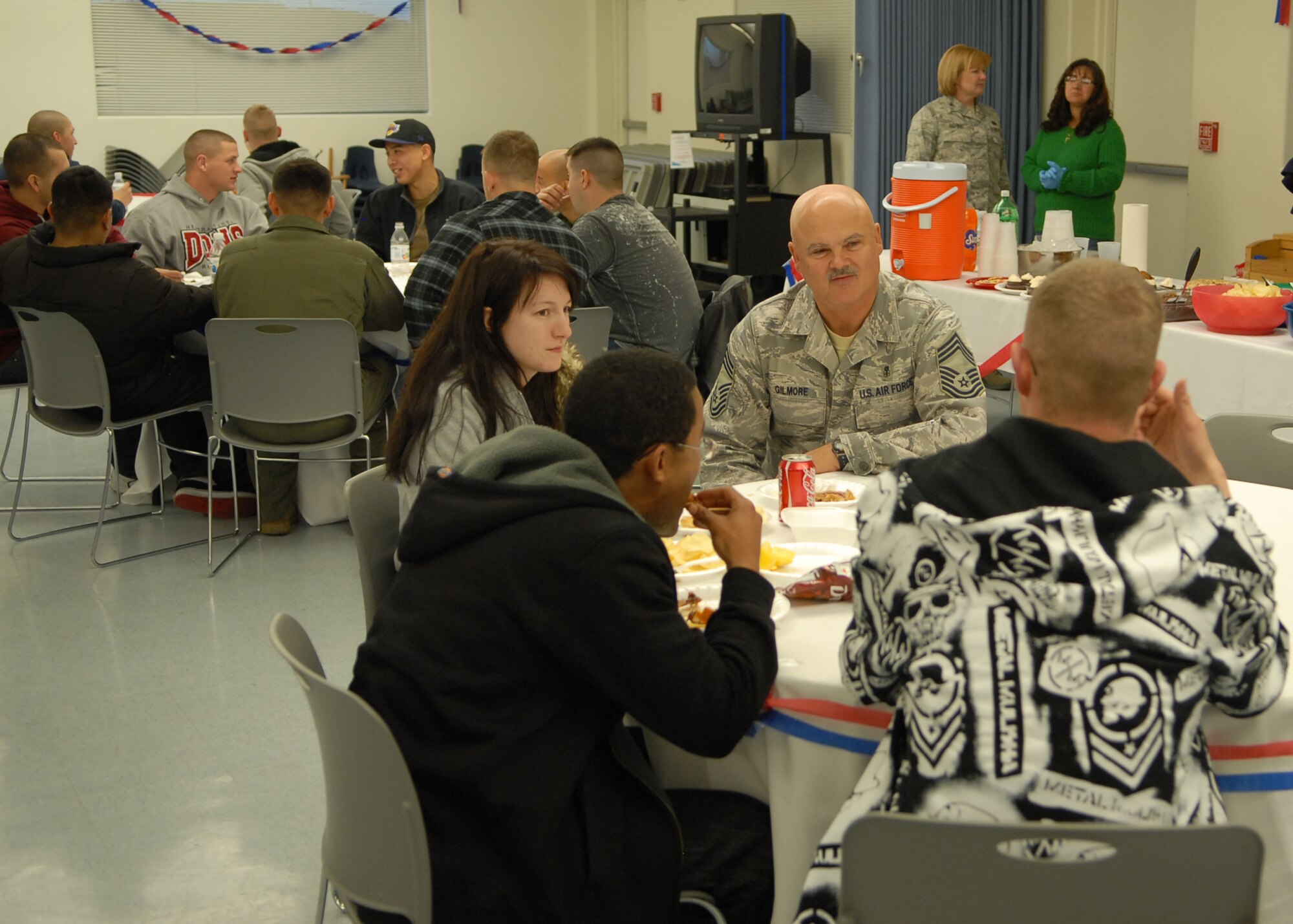 Chief Master Sgt. David Gilmore, 95th Medical Group superintendent, talks with Airman during the Dorm Dinner at the Chapel 1 Annex here Feb. 24.  The dinner was served by base leadership from across the base. (Air Force photo/Airman 1st Class William O'Brien)