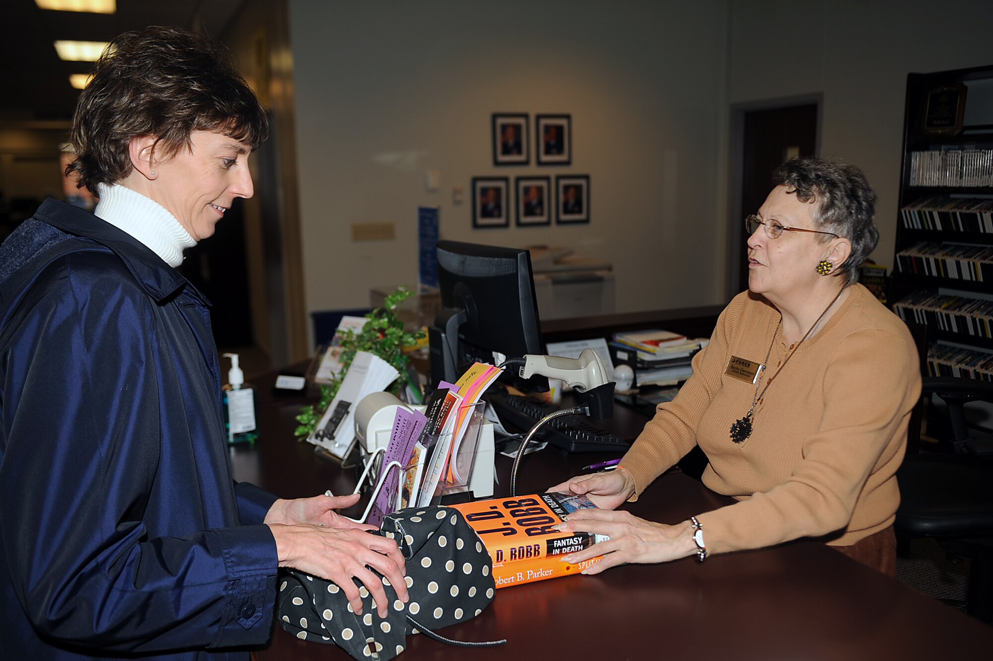 Becky Dennison, 4th Force Support Squadron library technician, checks out books to Cathy Senatz, 4th Force Support Squadron human resources technician, at the Watkins-Das Learning Center on Seymour Johnson Air Force Base, N.C., Feb 26, 2010. The library has CDs, DVDs, magazines, audio books and Rosetta Stone CD-ROMs available for check-out. Dennison has worked in the library system since 1973, and hails from Kansas City, Mo. Senatz is from Wellsbridge, N.Y. (U.S. Air Force photo/Senior Airman Ciara Wymbs) 