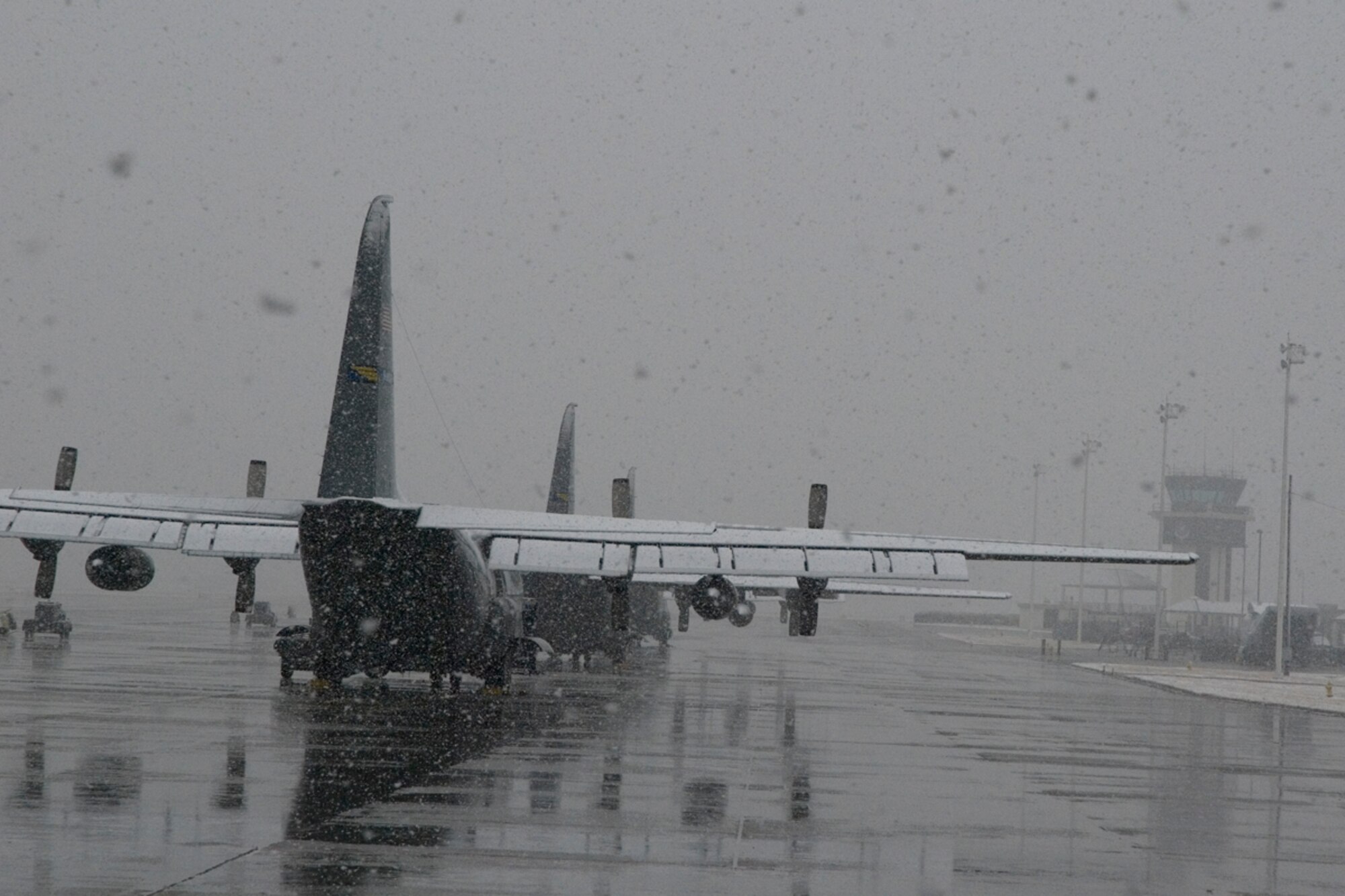 Snow blankets C-130 aircraft lined up on the flight line March 2. Employees at Dobbins Air Reserve Base are dismissed at 3 p.m. March 2 and will report to work at 9 a.m. March 3. 