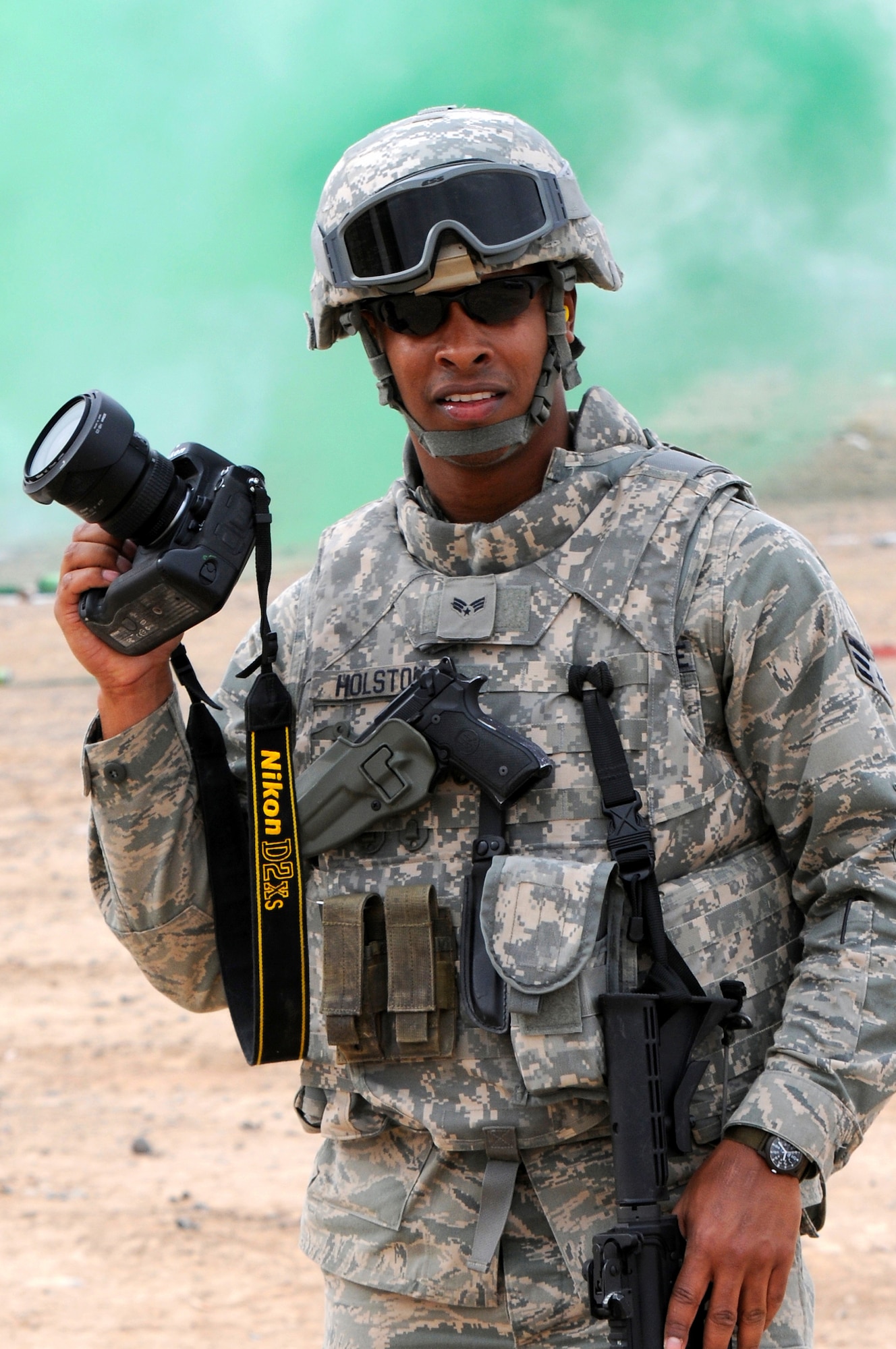 KANDAHAR, Afghanistan -Senior Airman Kenny Holston, 205th Coalition Mentoring Team public affairs, documents weapons training and familiarization at Tarnak Weapons firing range, Jan. 21, 2010, Kandahar, Afghanistan.  Airman Holston is currently deployed from the 509th Bomb Wing Public Affairs Office. (U.S. Air Force photo/Master Sgt.  Julie Avey)(Released)