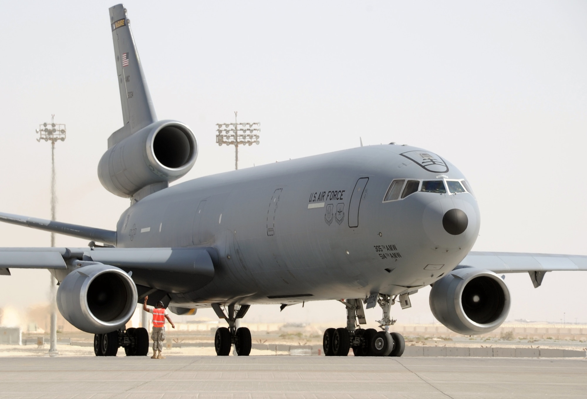 A flight crew guides a KC-10 Extender assigned to the 908th Expeditionary Air Refueling Squadron of the 380th Air Expeditionary Wing out for a mission during flightline operations at a non-disclosed base in Southwest Asia. In 2009, KC-10s from the 380th AEW and the 908th EARS flew 4,760 combat sorties offl-loading 422,222,300 pounds of fuel to 31,434 aircraft. In the same year, the KC-10s and their crews accumulated 40,011 hours of flight time. The 380th AEW supports operations Iraqi Freedom and Enduring Freedom and the Combined Joint Task Force-Horn of Africa. (U.S. Air Force Photo/Master Sgt. Scott T. Sturkol/Released)