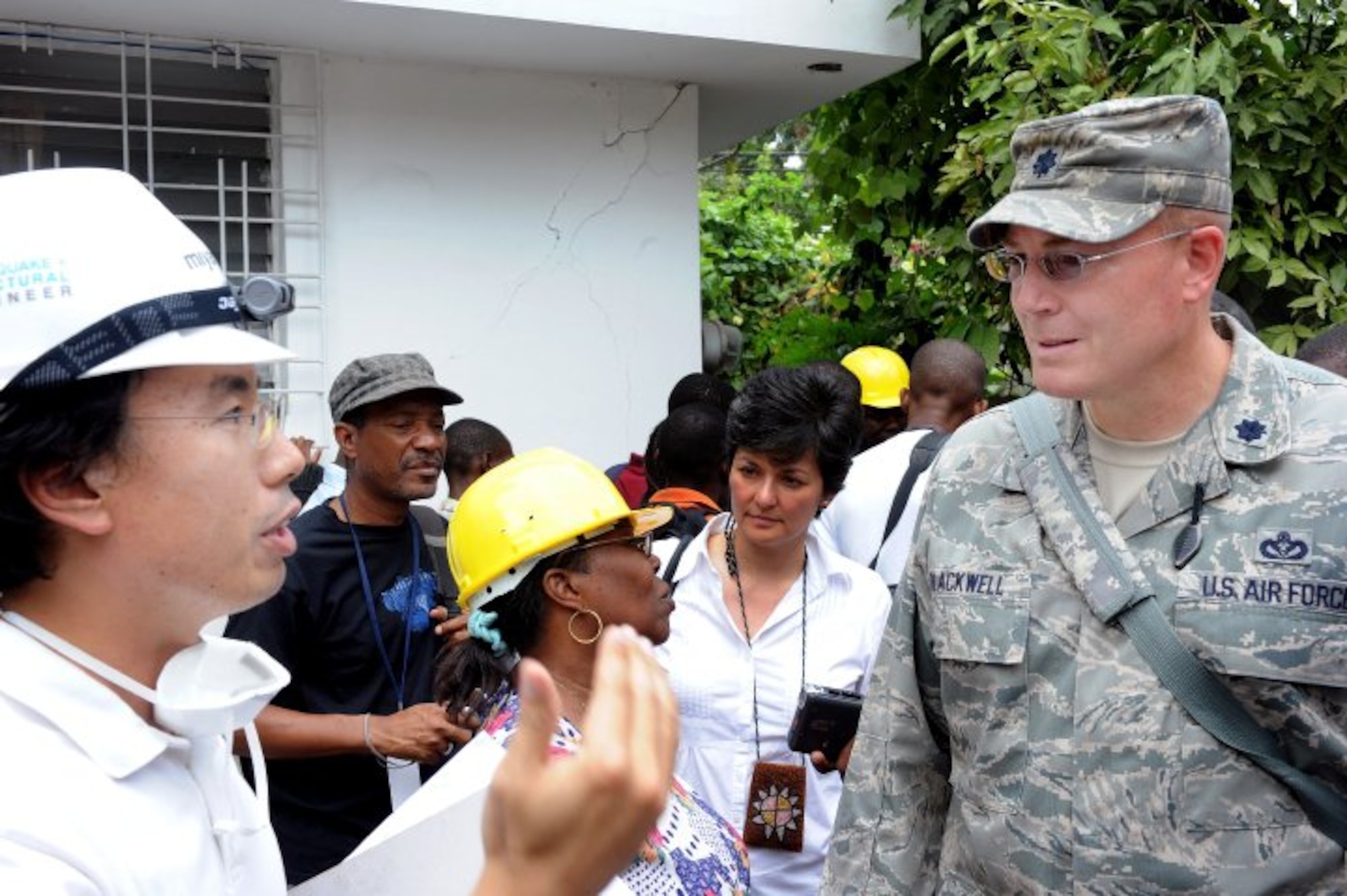Turgean, Haiti - Soon-Min Kwon from Miyamoto, a Structural Engineering Consulting firm out of Sacramento, Calif., and a UN Office for Partnerships partner, speaks to Lt. Col. John Blackwell, currently deployed from Tyndall Air Force Base as the Joint Task Force-Haiti Deputy Engineer about the training being given to engineers of Haiti’s Ministry of Public Works. (U.S. Navy Photo by Interior Communications Electrician First Class Jason Richard Stephens/Released)
