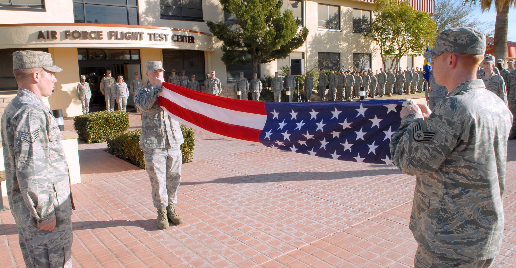 Members of the 412th Maintence Squadron fold the American Flag during Edwards monthly retreat ceremony at the Air Force Flight Test Center Headquarters Feb. 25. A retreat ceremony marks the end of the duty day and honors the American Flag. (Air Force photo/Airman 1st Class William A. O'Brien)