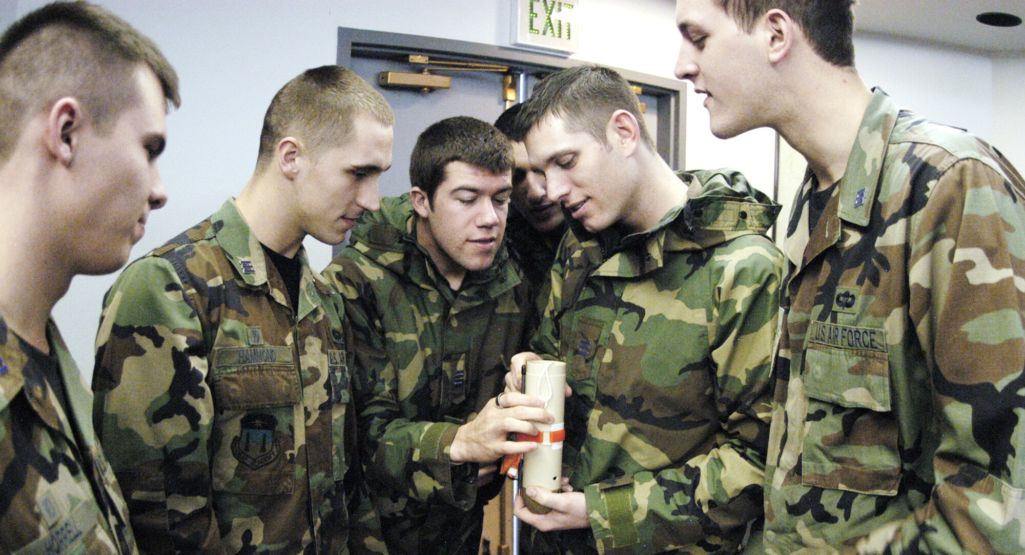 U.S. Air Force Academy Cadets 1st Class Mark Hammond, Jeff Reddout, Lucas Catalino and Philip Husk examine a dropsonde at the 731st Airlift Squadron Feb. 9, 2010, at Peterson Air Force Base, Colo. The cadets are part of the Spring 2010 Aeronautical Engineering 482 class on aircraft design. A core element of their course is the feasibility of deploying a dropsonde via a remotely piloted aircraft to increase airdrop accuracy. (U.S. Air Force photo/John Van Winkle)