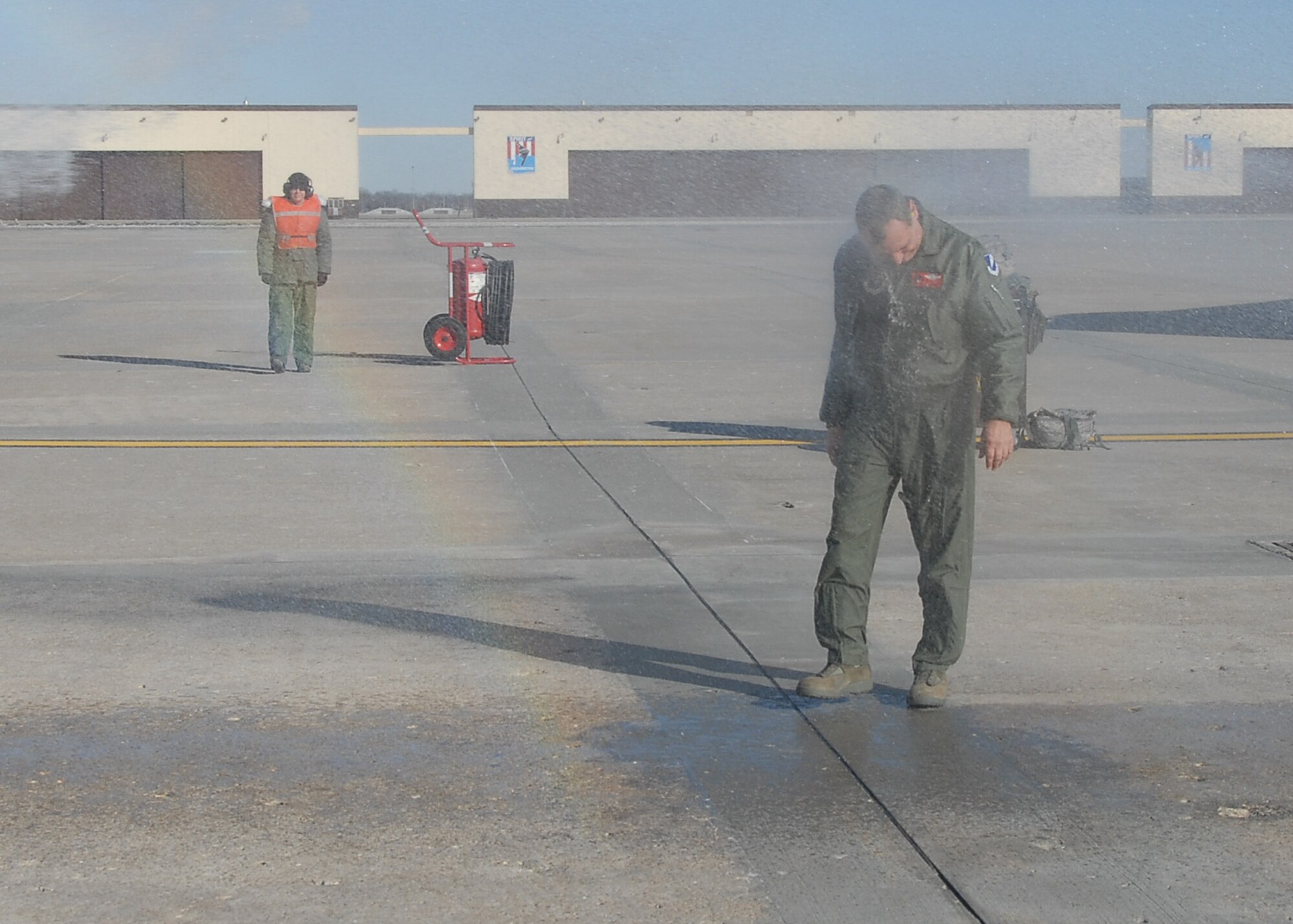 DOUSED! 
Col Robert "Herm" Leeker, 131st Bomb Wing Commander, Missouri Air National Guard, is doused with a fire hose in honor of his final B-2 flight at Whiteman Air Force Base on February 25.  (U.S. Air Force Photo by Master Sergeant Mary-Dale Amison.  RELEASED)  

