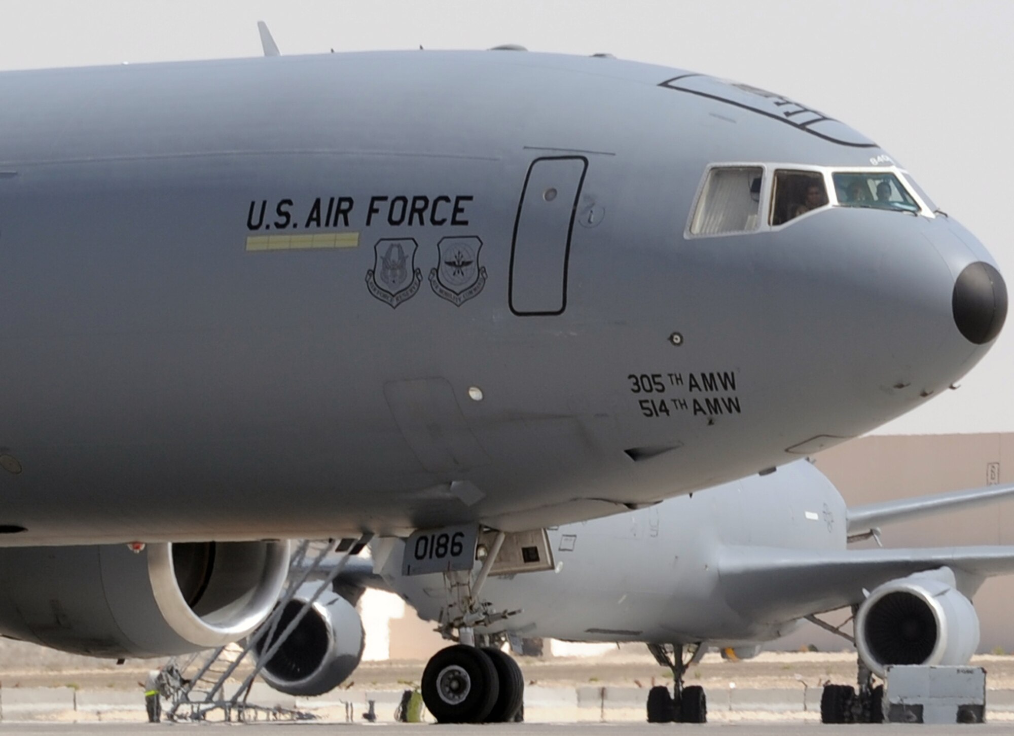 A flight crew guides a KC-10 Extender assigned to the 908th Expeditionary Air Refueling Squadron of the 380th Air Expeditionary Wing out for a mission during flightline operations at a non-disclosed base in Southwest Asia. In 2009, KC-10s from the 380th AEW and the 908th EARS flew 4,760 combat sorties offl-loading 422,222,300 pounds of fuel to 31,434 aircraft. In the same year, the KC-10s and their crews accumulated 40,011 hours of flight time. The 380th AEW supports operations Iraqi Freedom and Enduring Freedom and the Combined Joint Task Force-Horn of Africa. (U.S. Air Force Photo/Master Sgt. Scott T. Sturkol/Released)