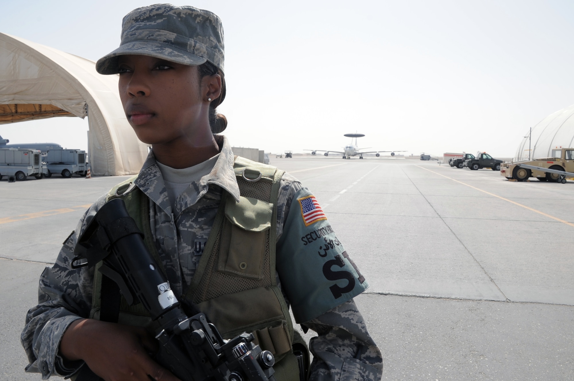 Airman 1st Class Shawntavia Gilot, a security forces journeyman with the 380th Expeditionary Security Forces Squadron, watches over a checkpoint during operations near the flightline for the 380th Air Expeditionary Wing at a non-disclosed base in Southwest Asia on Feb. 23, 2010. Airman Gilot is deployed from the 87th Security Forces Squadron at Joint Base McGuire-Dix-Lakehurst, N.J., and her hometown is Miami, Fla. The 380th ESFS, as part of the 380th AEW, supports operations Iraqi Freedom and Enduring Freedom and the Combined Joint Task Force-Horn of Africa. (U.S. Air Force Photo/Master Sgt. Scott T. Sturkol)