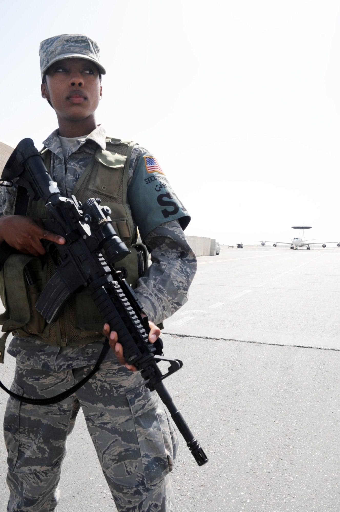 Airman 1st Class Shawntavia Gilot, a security forces journeyman with the 380th Expeditionary Security Forces Squadron, watches over a checkpoint during operations near the flightline for the 380th Air Expeditionary Wing at a non-disclosed base in Southwest Asia on Feb. 23, 2010. Airman Gilot is deployed from the 87th Security Forces Squadron at Joint Base McGuire-Dix-Lakehurst, N.J., and her hometown is Miami, Fla. The 380th ESFS, as part of the 380th AEW, supports operations Iraqi Freedom and Enduring Freedom and the Combined Joint Task Force-Horn of Africa. (U.S. Air Force Photo/Master Sgt. Scott T. Sturkol)