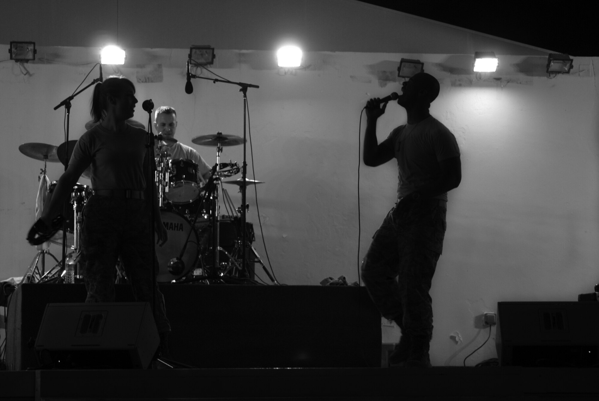 Airman 1st Class Jill Diem, Reserve Generation vocalist, Tech. Sgt. David Vittetoe, drummer, and Master Sgt. Aaron Miles, vocalist and NCO in charge, perform at their second deployed gig in Southwest Asia Feb. 27. Reserve Generation is the current U.S. Air Forces Central Command Band. (U.S. Air Force photo/Senior Airman Dillon White/released)