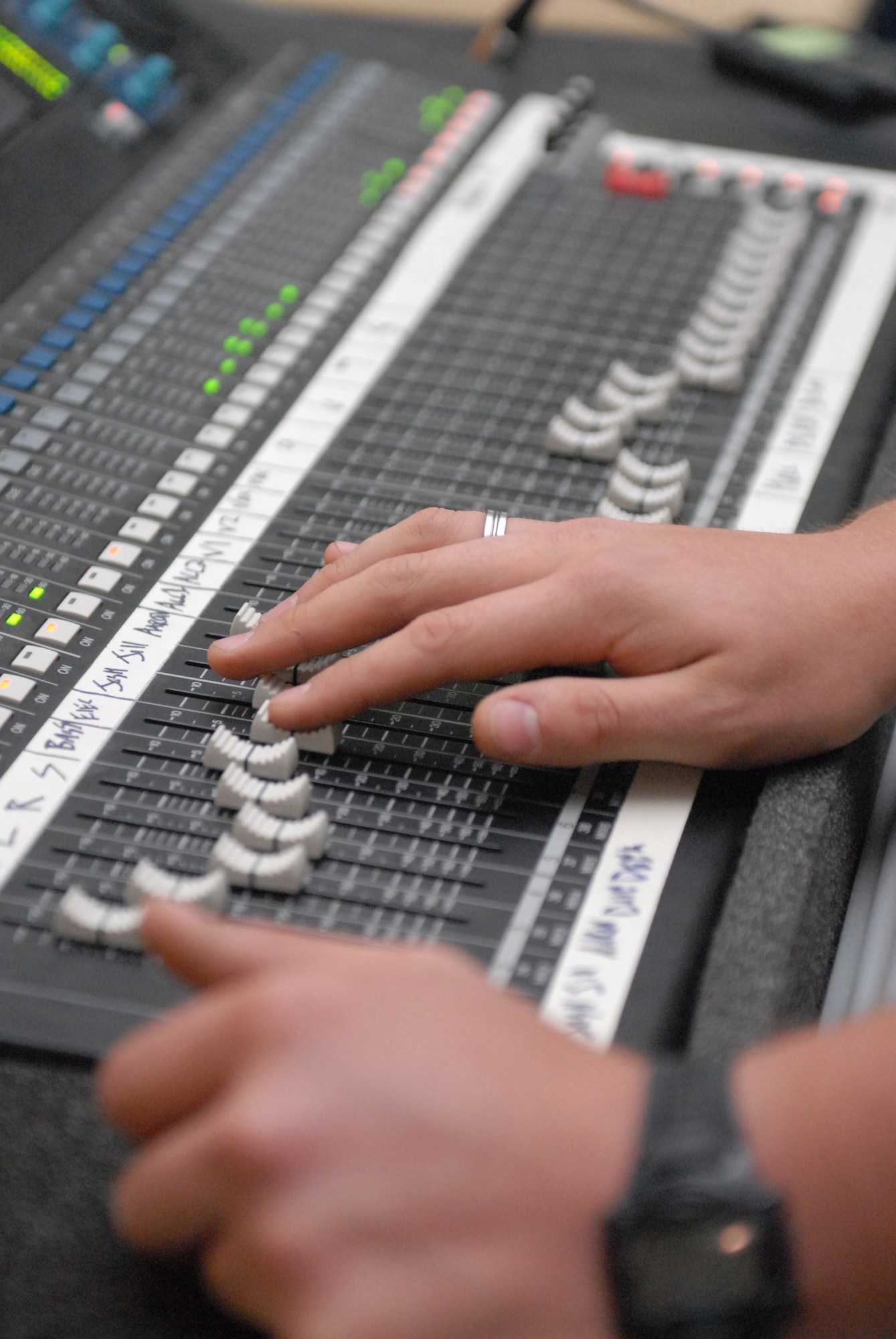 Airman 1st Class Jack Bowers, Reserve Generation audio technician, sets sound levels during the band's second deployed gig in Southwest Asia Feb. 27. (U.S. Air Force photo/Senior Airman Dillon White/released)