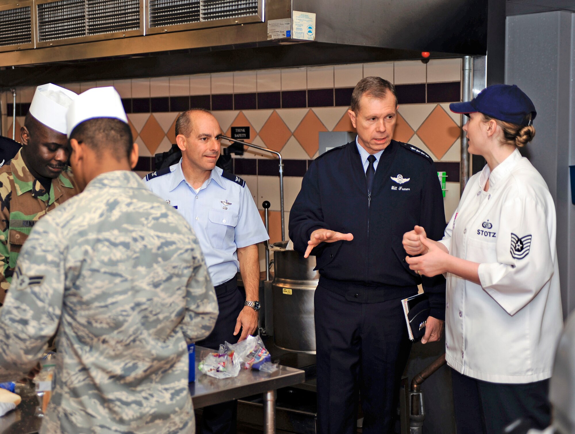 Gen. William M. Fraser III receives a description of the kitchen and food preparation area of the Shifting Sands Dining Facility by Tech. Sgt. Joya Stotz Feb. 22, 2010, at Holloman Air Force Base, N.M. General Fraser is the commander of Air Combat Command. Sergeant Stotz is assigned to the 49th Force Support Squadron. (U.S. Air Force photo/Senior Airman DeAndre Curtiss)