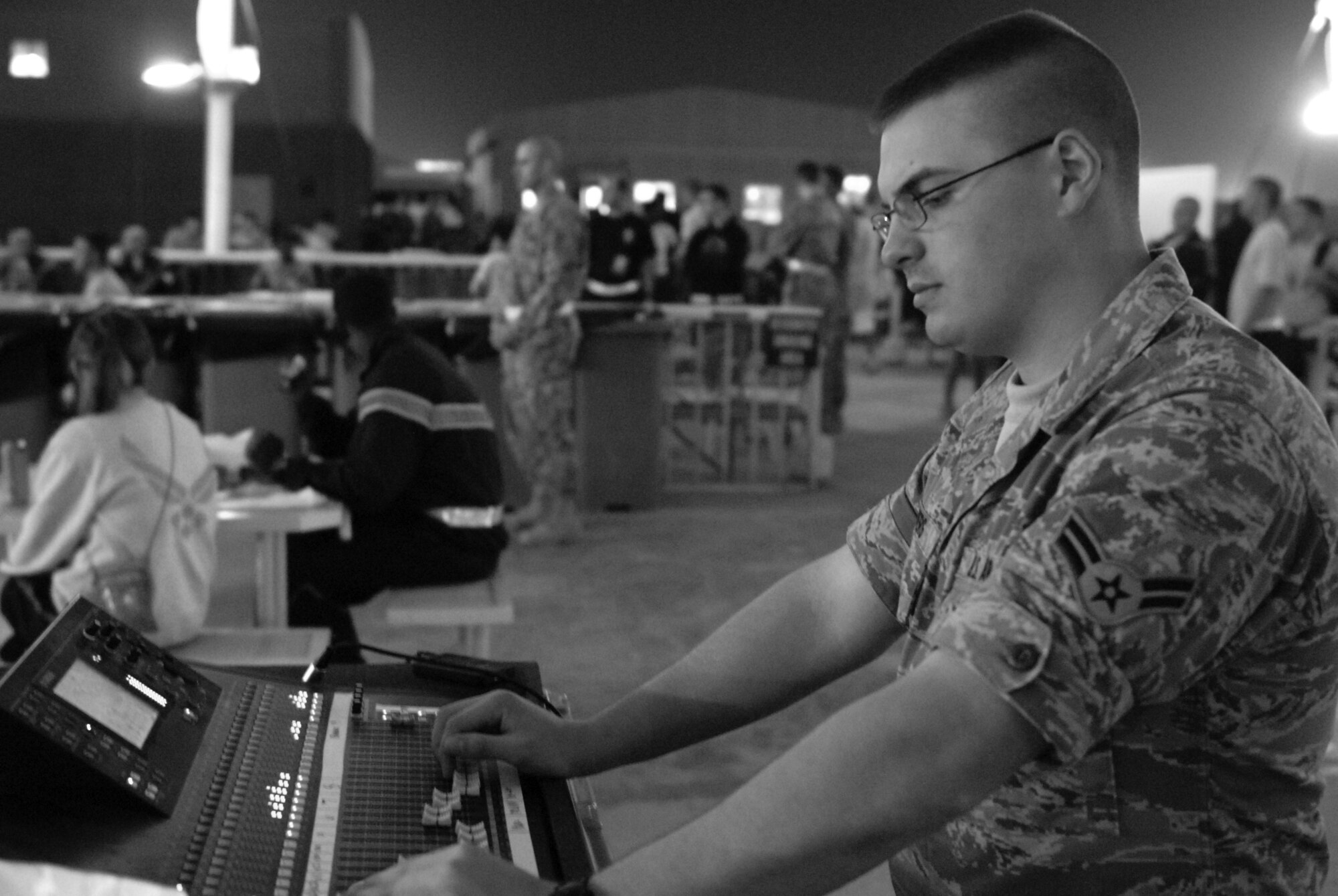 Airman 1st Class Jack Bowers, Reserve Generation audio technician, monitors audio levels during the band's second deployed performance in Southwest Asia Feb. 27. During the next 60 days, Airman Bowers will be setting up his band's equipment at various locations across Iraq, Afghanistan and Southwest Asia. (U.S. Air Force photo/Senior Airman Dillon White/released)