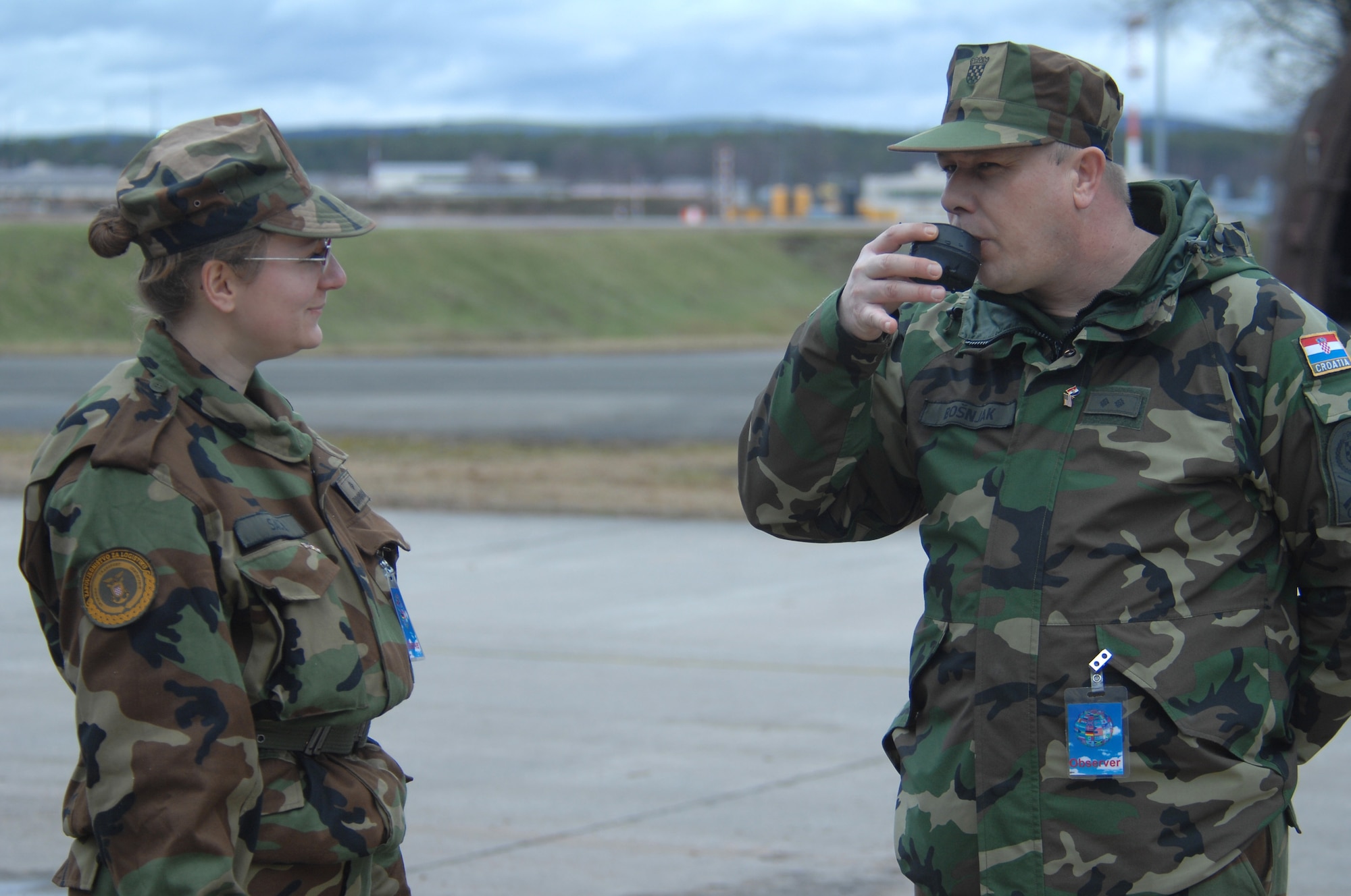 Croatian Army 2nd Lt. Sabina Sacer and Private 1st Class Stanko Bosnjak take a taste of water they have just purified using the H9518-1 reverse osmosis water purification unit. This year’s Silver Flag Exercise hosted here Feb. 21 - 28 allowed USAFE Airmen, Air Force Reserve and members of the Croatian Army for the first time to observe how Airmen prepare to deploy to austere locations. (U.S. Air Force photo by Tech. Sgt. Michael Voss)