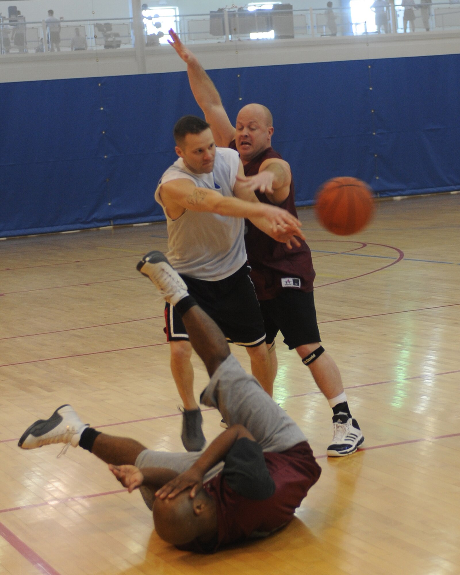 MINOT AIR FORCE BASE, N.D. – Staff Sgt. Joseph Scott, 5th Medical Operations Squadron Bioenvironmental readiness and training non-commissioned officer in charge, breaks through a double team during the Over 30 Intramural Basketball League championship game at the McAdoo Fitness Center on Minot Air Force Base Feb. 24. The 5th Medical Group defeated the 91st Operations Group 48-30 and captured their third consecutive over 30 league championship. (U.S. Air Force photo by Senior Airman Sharida Jackson)