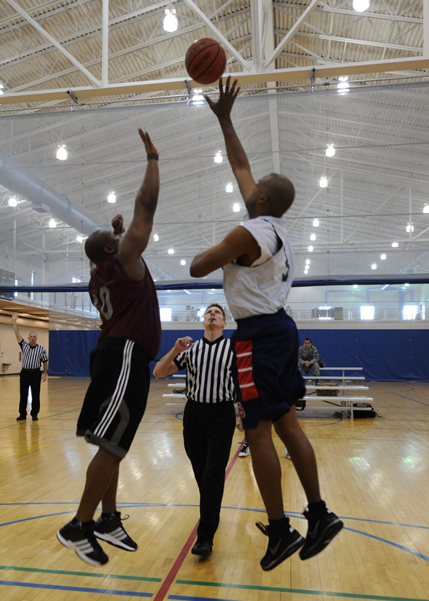 MINOT AIR FORCE BASE, N.D. – Tech. Sgt. Keon Pinckney, 742nd Missile Squadron missile chef non-commissioned officer in charge, and Master Sgt. Troy Myles, 5th Medical Operations squadron dental flight chief, jump for the ball at tip-off during the Over 30 Intramural Basketball League championship game at the McAdoo Fitness Center on Minot Air Force Base Feb. 24. The 5th Medical Group defeated the 91st Operations Group 48-30 and captured their third consecutive over 30 league championship. (U.S. Air Force photo by Senior Airman Sharida Jackson)