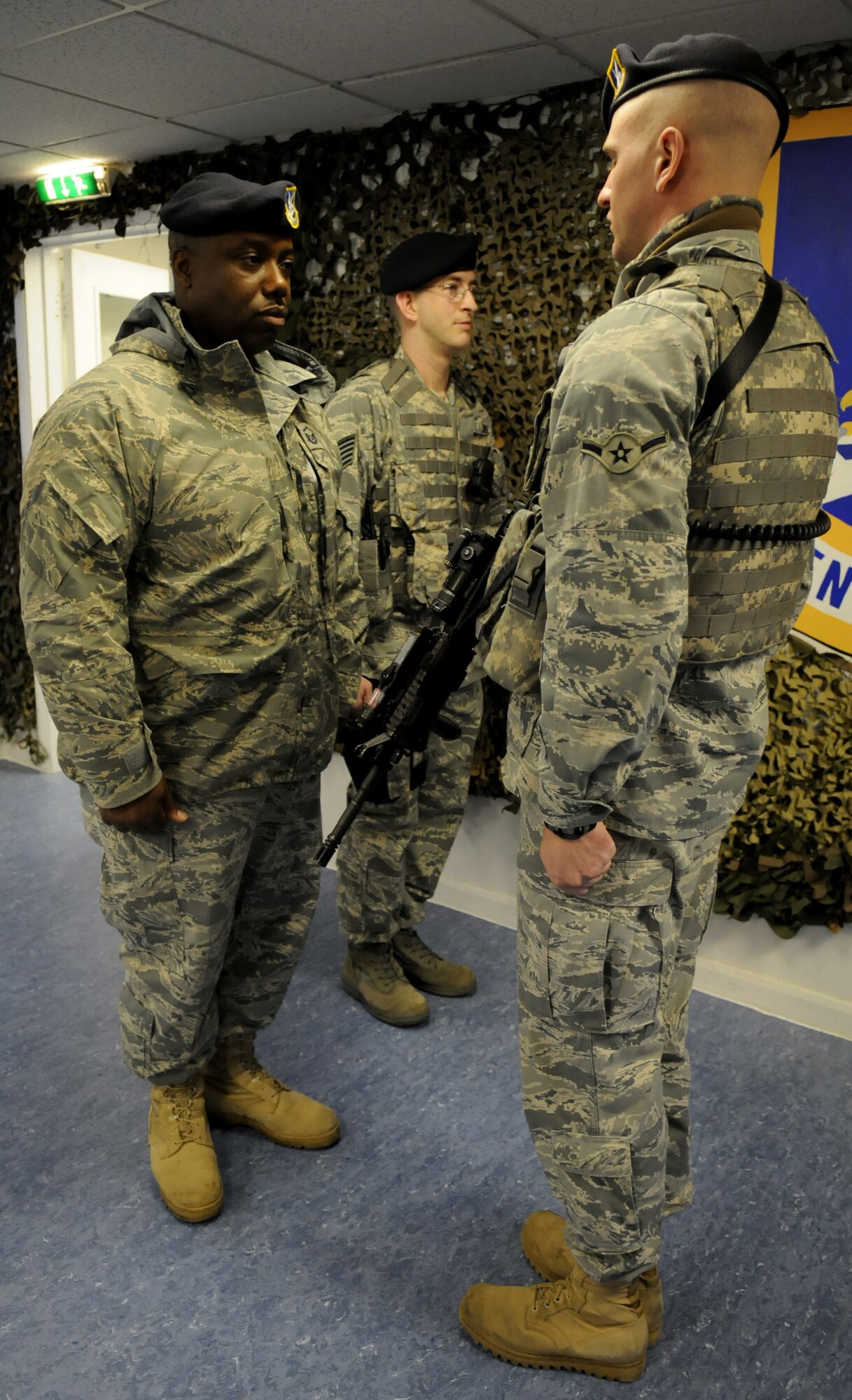 Master Sgt. Emmett Tibbs, 100th Security Forces Squadron Operations superintendent (left), inspects Amn. Cole Shaffer?s uniform and equipment prior to his shift with the 100th SFS Delta Flight March 1. Tech. Sgt. Kenneth Johnson, Delta?s flight sergeant, stands by during the inspection. Airman Shaffer hails from Rifle, Colo., and has been stationed at RAF Mildenhall for about eight months. (U.S. Air Force photo by Staff Sgt. Jerry Fleshman)