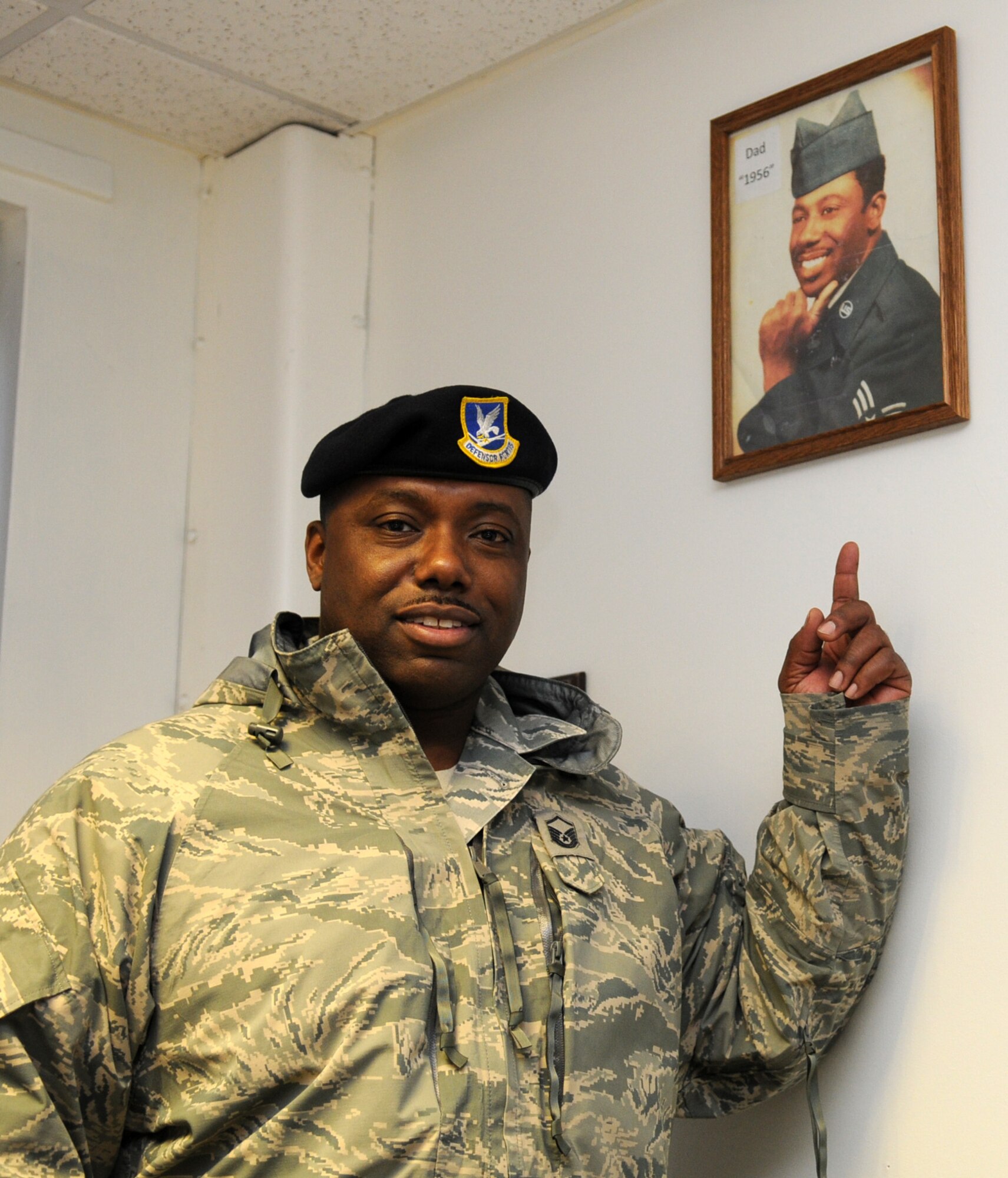 Master Sgt. Emmett Tibbs, 100th Security Forces Squadron Operations superintendent, points to a photo of his hero, a 1956 photo of Sgt. Emmett Brown, his father. Sergeant Tibbs was recently named the 2009 U.S. Air Forces in Europe outstanding flight level senior non-commissioned officer of the year. (U.S. Air Force photo by Staff Sgt. Jerry Fleshman)