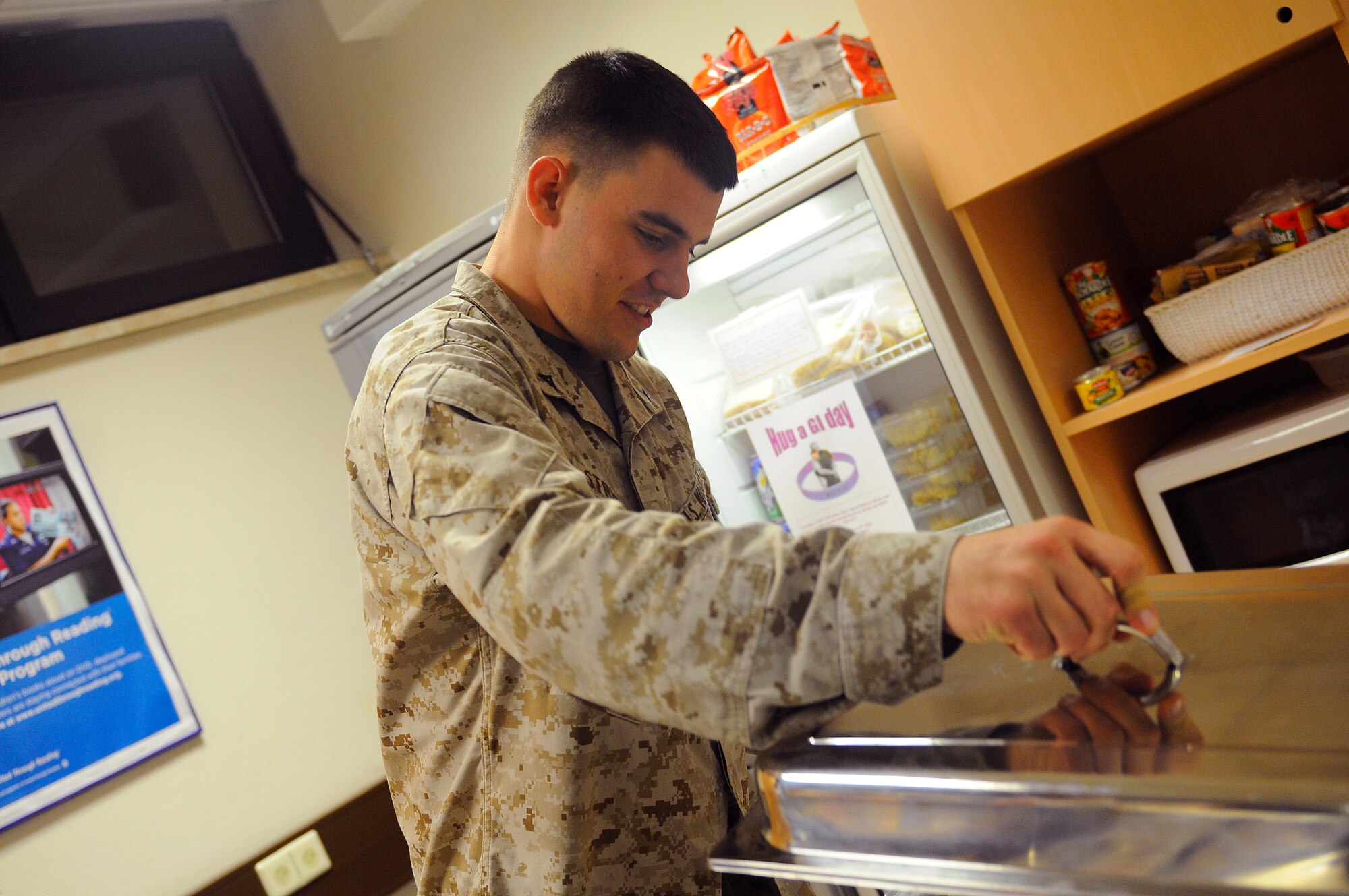 U.S. Marine Corps Lance Cpl. Luke Stricevic, infantry rifleman, 4th Battalion Landing Team, Camp Pendleton, California, prepares his plate at the Contingency Aeromedical Staging Facility (CASF) on Ramstein Air Base, Germany, Feb. 25, 2010. Corporal Stricevic sat down for a home cooked meal made by 'Mama' West during his stay at the CASF. (U.S. Air Force photo by Airman 1st Class Brea Miller)