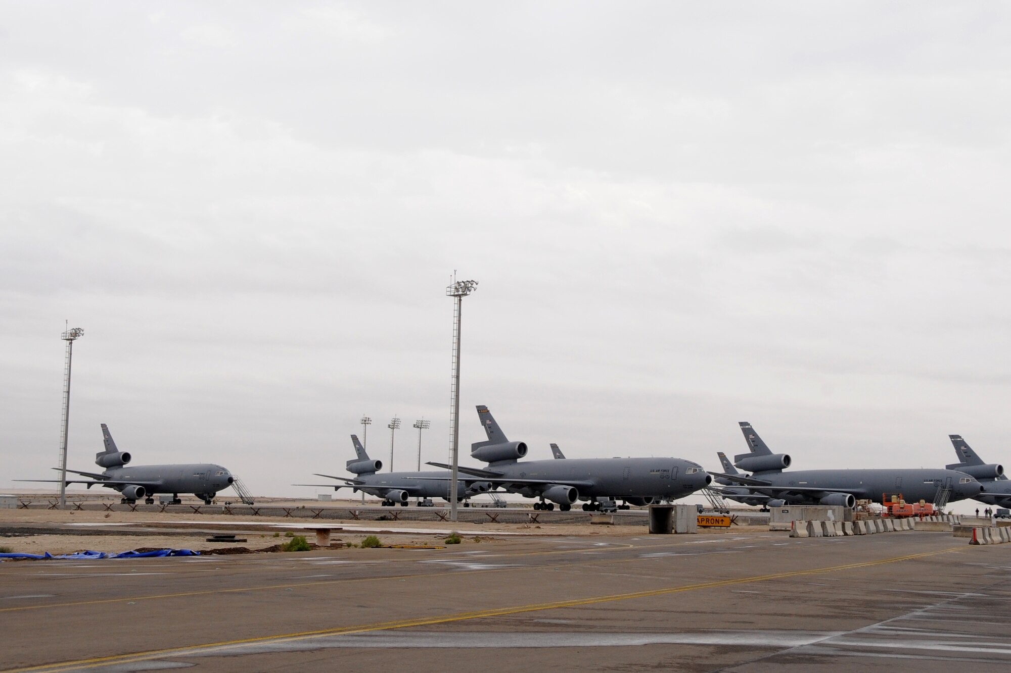 KC-10 Extenders sit on the flightline at the 380th Air Expedionary Wing March 2, 2010. The 380th recieved .25-.50 inches of rain in an area that usually recieves only 3-5 inches for the year with wind gust getting up to 43 knots. the 380th Air Expeditionary Wing, supports Operations Iraqi Freedom and Enduring Freedom and the Combined Joint Task Force-Horn of Africa. The 380th AEW is comprised of four groups and 12 squadrons and the wing's deployed mission includes air refueling, surveillance and reconnaissance in support of overseas contingency operations in Southwest Asia. (U.S. Air Force photo/Senior Airman Jenifer H. Calhoun/Released)
