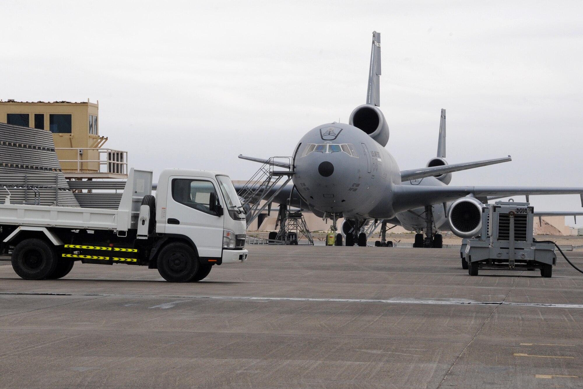 A KC-10 Extender sits on the flightline at the 380th Air Expedionary Wing March 2, 2010. The 380th recieved .25-.50 inches of rain in an area that usually recieves only 3-5 inches for the year with wind gust getting up to 43 knots. the 380th Air Expeditionary Wing, supports Operations Iraqi Freedom and Enduring Freedom and the Combined Joint Task Force-Horn of Africa. The 380th AEW is comprised of four groups and 12 squadrons and the wing's deployed mission includes air refueling, surveillance and reconnaissance in support of overseas contingency operations in Southwest Asia. (U.S. Air Force photo/Senior Airman Jenifer H. Calhoun/Released)
