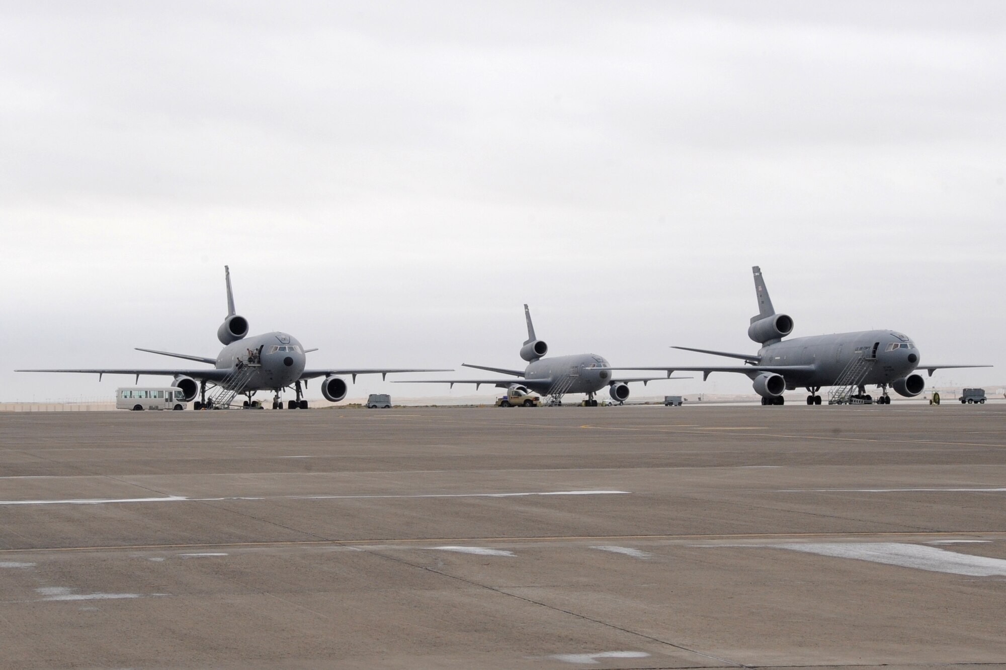 KC-10 Extenders sit on the flightline at the 380th Air Expedionary Wing March 2, 2010. The 380th recieved .25-.50 inches of rain in an area that usually recieves only 3-5 inches for the year with wind gust getting up to 43 knots. the 380th Air Expeditionary Wing, supports Operations Iraqi Freedom and Enduring Freedom and the Combined Joint Task Force-Horn of Africa. The 380th AEW is comprised of four groups and 12 squadrons and the wing's deployed mission includes air refueling, surveillance and reconnaissance in support of overseas contingency operations in Southwest Asia. (U.S. Air Force photo/Senior Airman Jenifer H. Calhoun/Released)
