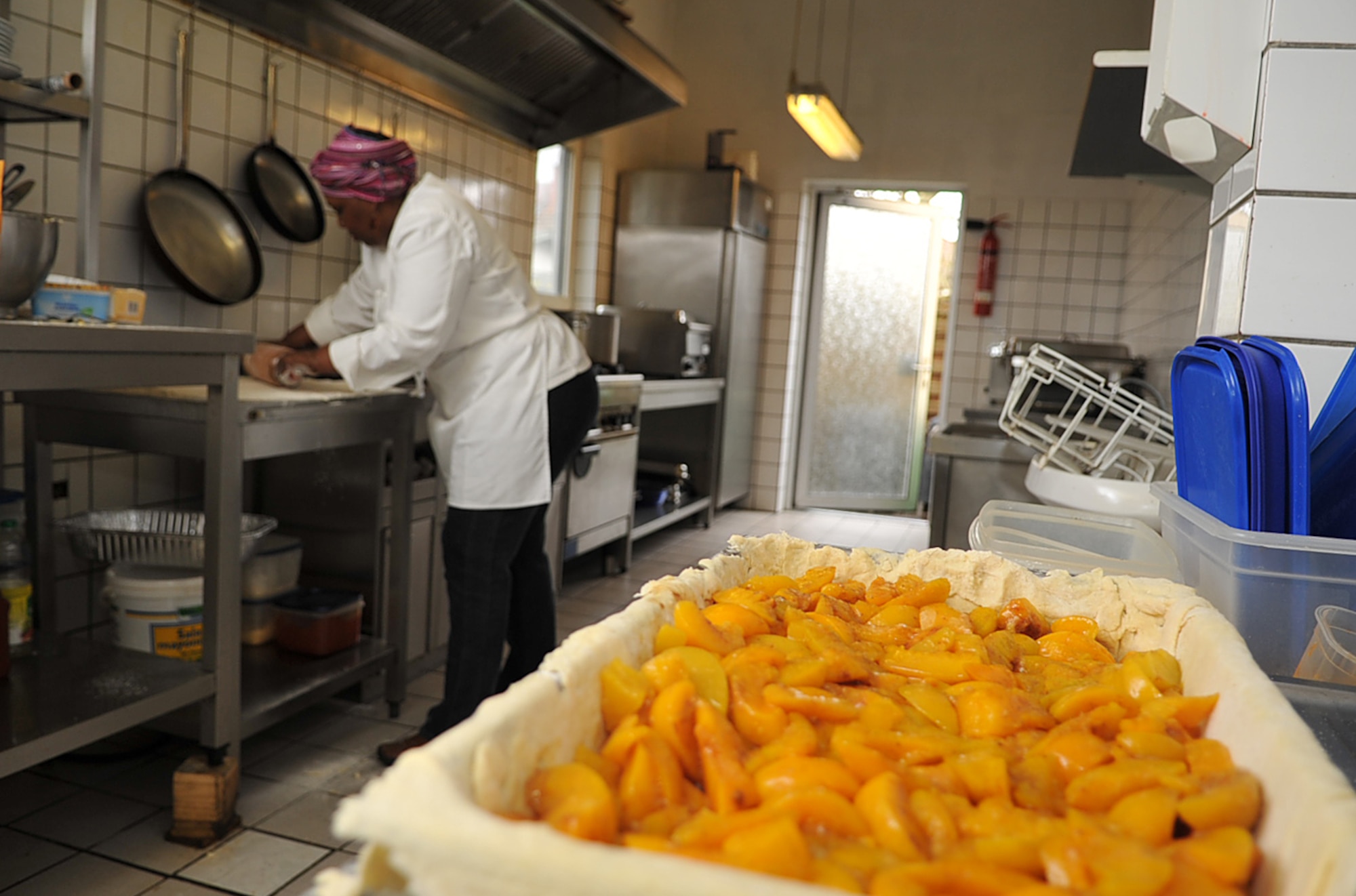 Brenda 'Mama' West, professional chef, cooks up a meal in the kitchen of her restaurant, Ramstein village, Germany, Feb. 25, 2010. Mama West has been volunteering her time and cooking skills to feed U.S. servicemembers and wounded warriors in the KMC for over a decade. (U.S. Air Force photo by Senior Airman Tony R. Ritter) 