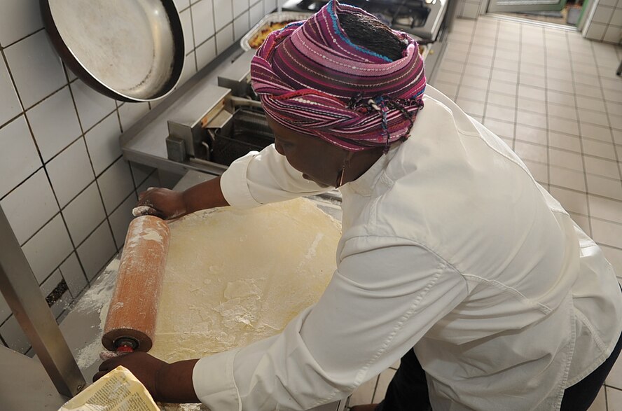 Brenda 'Mama' West, professional chef, rolls out a crust for a cobbler in the kitchen of her restaurant, Ramstein village, Germany, Feb. 25, 2010. Mama West has been volunteering her time and cooking skills to feed U.S. servicemembers and wounded warriors in the KMC for over a decade. (U.S. Air Force photo by Senior Airman Tony R. Ritter) 
 
