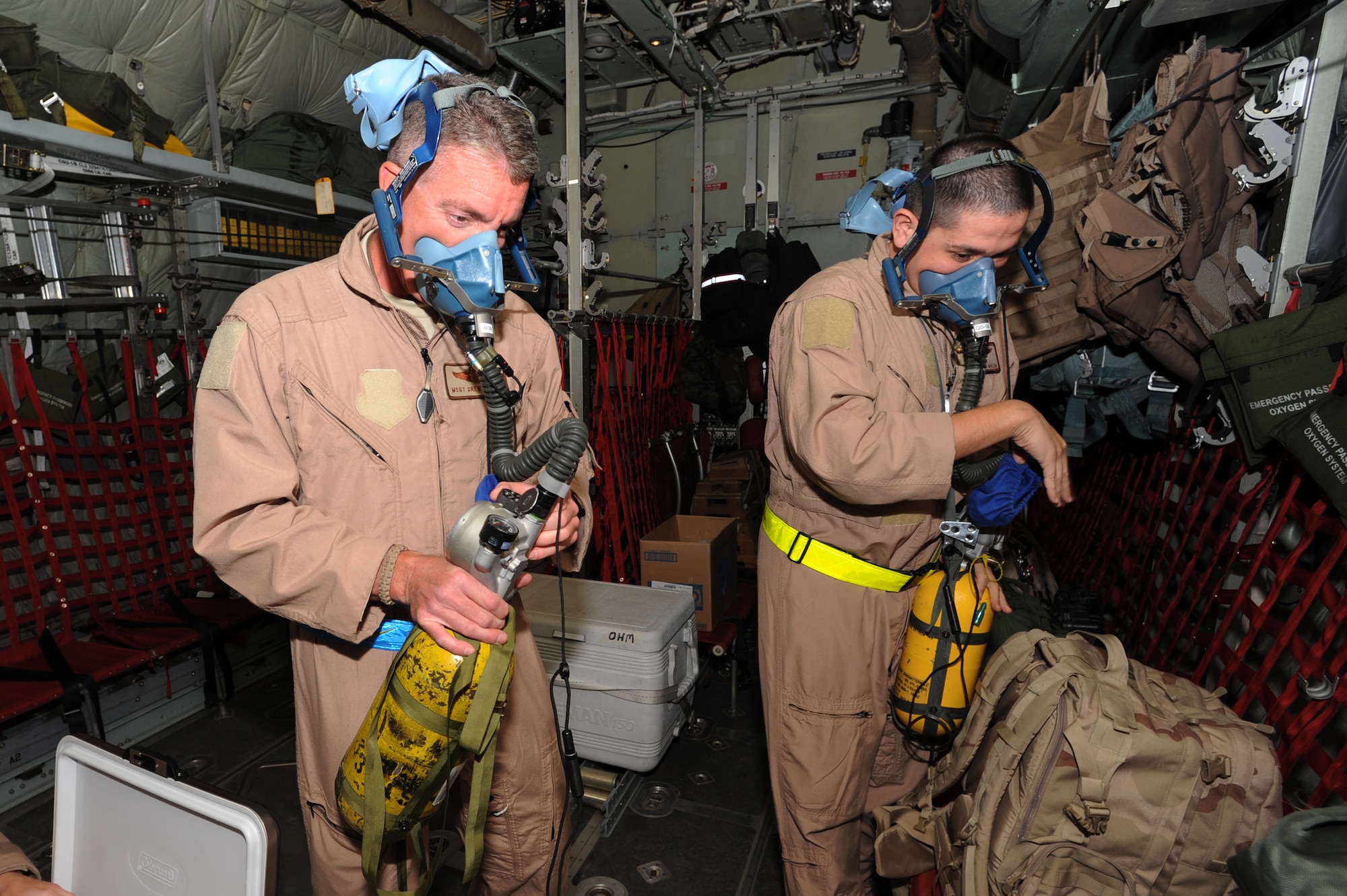 Master Sgt. Andrew McCabe and Tech. Sgt. Steven Guillen, 379th Expeditionary Aeromedical Evacuation Squadron aeromedical evacuation technicians, perform pre-flight checks on therapeutic oxygen kits at a non-disclosed Southwest Asia location, Feb 20, 2010. (U.S. Air Force photo by Tech. Sgt. Michelle Larche)