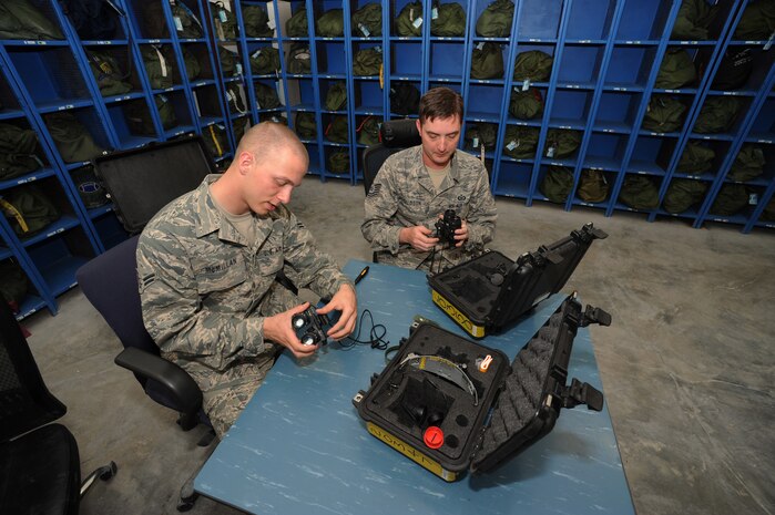 Airman 1st Class Chris McMillan and Tech. Sgt. Michael Donaldson, 816th Expediitionary Airlift Squadron aircrew flight equipment technicians, perform a post-mission inspection on night vision goggles at a non-disclosed Southwest Asia location, Jan. 29, 2010. (U.S. Air Force photo by Tech. Sgt. Michelle Larche)[RELEASED]