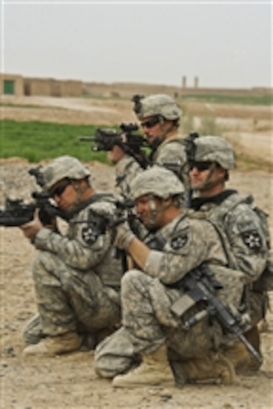 U.S. Army soldiers from 4th Battalion, 23rd Infantry Regiment provide security as soldiers from the 402nd Brigade Support Battalion prepare to tow their battle-damaged Stryker armored vehicle during Operation Helmand Spider in Badula Qulp, Afghanistan, on Feb. 26, 2010.  