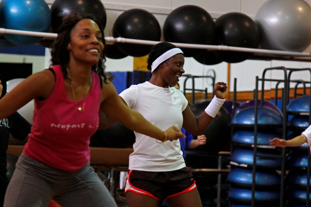Demetrius Hale (left) and Rhonda Jackson (right) move in sync to the beats of the music during the Zumba class held at the IronWorks Gym here March 3. The Zumba class::r::::n::is one of many classes offered by Marine Corps::r::::n::Community Services.