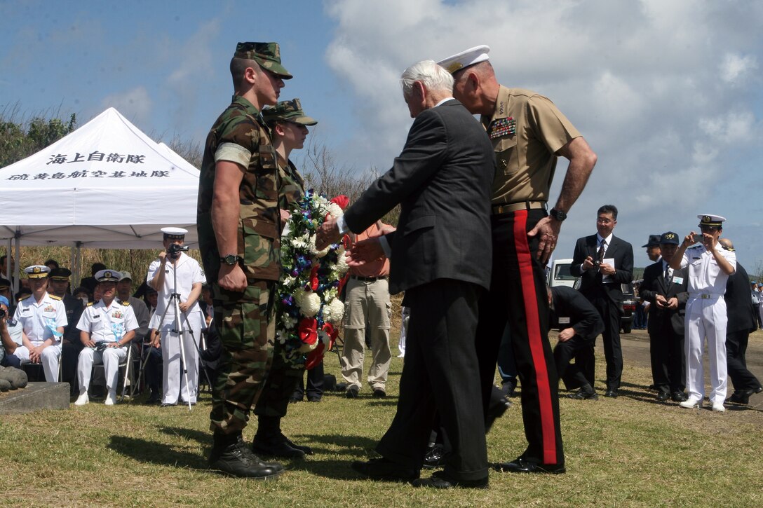 Commandant of the Marine Corps General James Conway, accompanied by retired Lt. Gen. Larry Snowden and U.S. Ambassador to Japan John Roos (not pictured), along with two students from the Young Marines program prepare to lay a wreath on the United States side of a joint memorial. The wreath laying was a significant part of the 65th Reunion of Honor commemoration of the Battle of Iwo Jima.