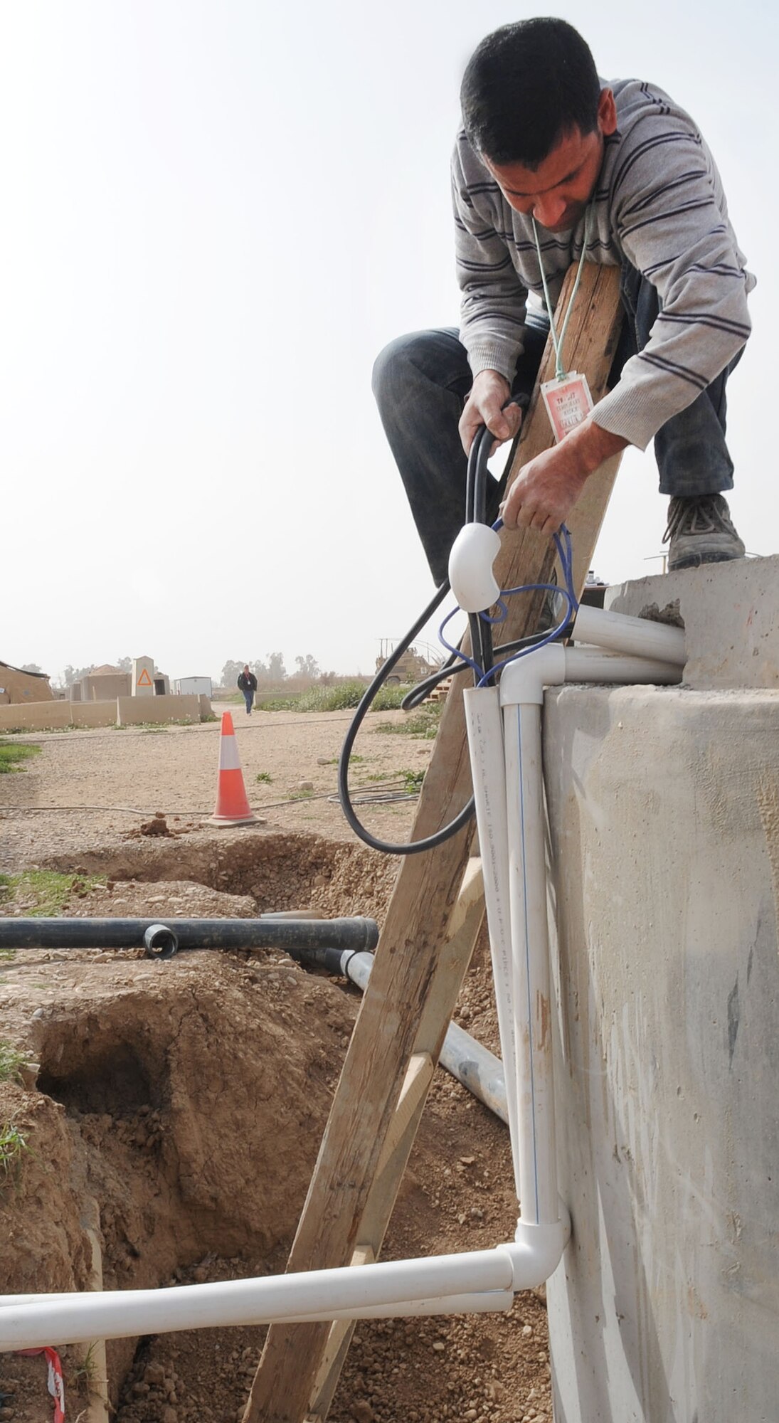 Crew members of Black Gold Holding Company, a local contractor, build a new lift station on Kirkuk Regional Air Base, Iraq on Feb. 24, 2010.  The crews constructed three new pump stations and modified five others.  As American forces drawdown the new lift station is one more positive sign Iraq has a bright future.  (U.S. Air Force photo/Staff Sgt. Tabitha Kuykendall/Released)	       