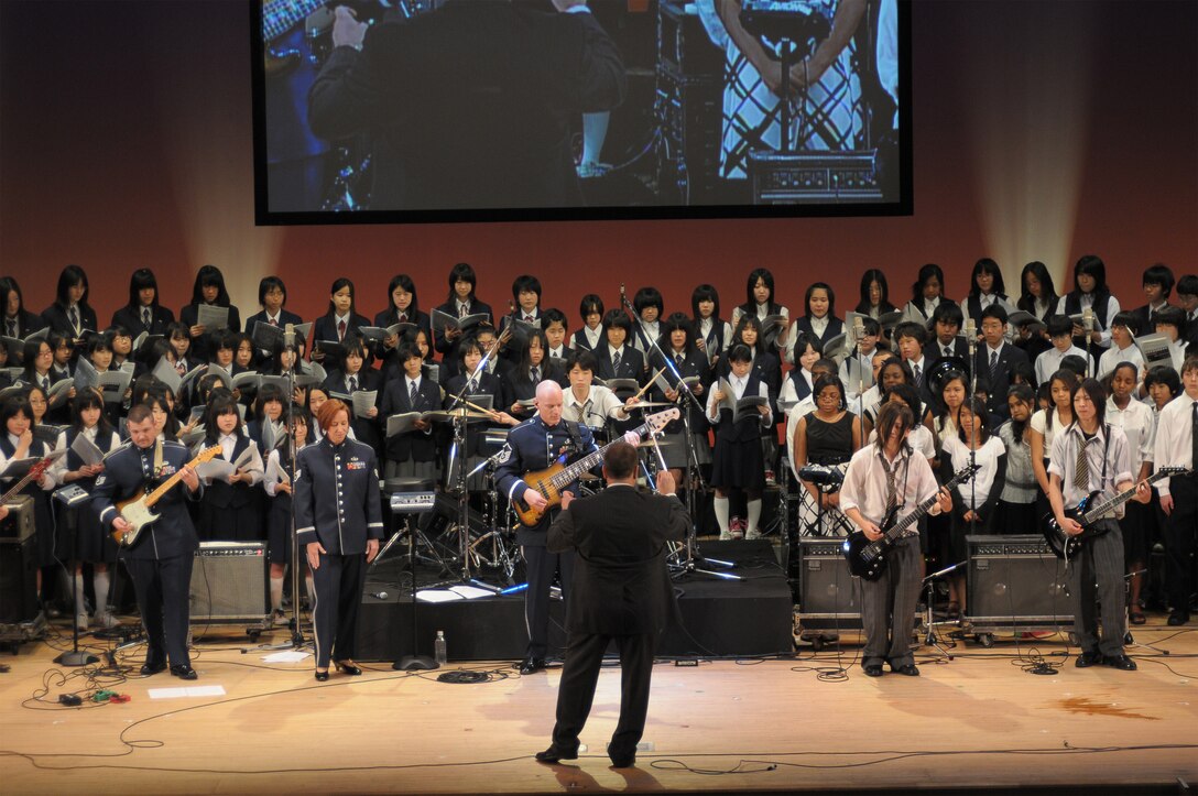 Final Approach performed with local Japanese high school students in a joint concert consisting of four choirs, horn players from Fussa wind ensemble, and the Tokyo Metropolitan Fussa high school rock band.  The theme was “Melody Line Connecting Hearts”.   Each group performed individually and everyone came together to perform the final selection “We Are the World”.  This event was a great way to enhance the relations and partnership that Yokota AB, and Fussa City/ local neighboring cities have shared over the past 50 years.  NCOIC of Final Approach MSgt Packard had this to say about the event, “This was a great opportunity to interact with our local neighbors, and share the importance of Yokota’s mission to the Japanese people.”