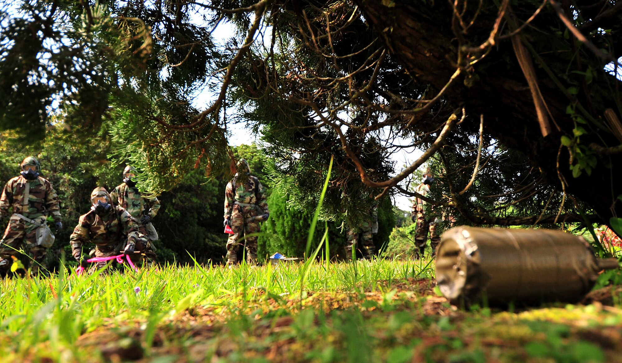 A group of Airmen from the 18th Munitions Squadron locate an unidentified explosive ordnance during an Ability to Survive and Operate (ATSO) course Feb. 24. The 18th MUNS held an ATSO course Feb. 24-March 2 for Airmen to hone their skills as AMMO warriors and learn how to perform their trade in a hostile environment. Over 200 members were trained in Mission Oriented Protective Posture wear, asset protection, post attack reconnaissance sweeps, UXO identification/reporting, and finished with a hands-on refresher of self aid buddy care.   (U.S. Air Force photo/Tech. Sgt. Rey Ramon)   