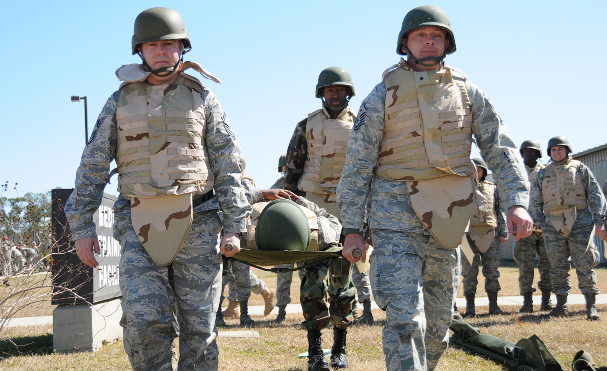 From left, Senior Master Sgt. Scott O’Hara, 81st Training Wing; Staff Sgt. Alvin Holmes, 81st Surgical Operations Squadron; and Master Sgt. Scott Passman, 335th TRS, carry Senior Airman Andrea Idudhe on a stretcher during self aid and buddy care training at the CRTC Feb. 25.  Airman Idudhe is assigned to the 81st Diagnostics and Therapeutics Squadron.  (U.S. Air Force photo by Kemberly Groue)