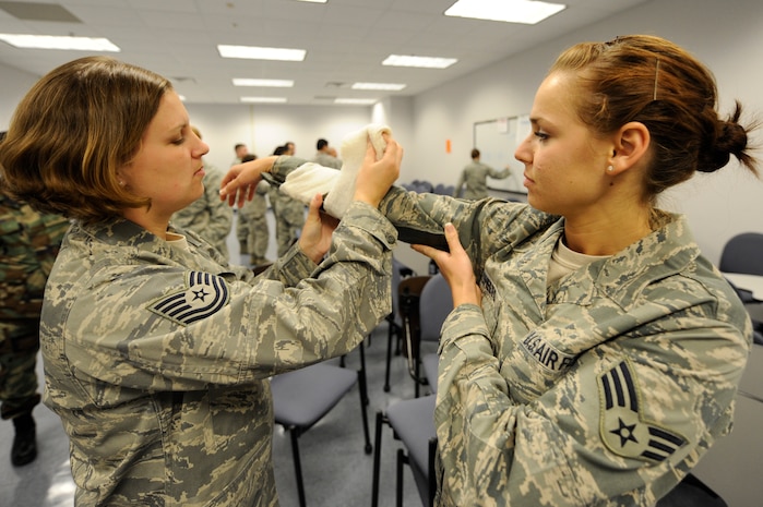 U.S. Air Force Tech. Sgt. Jennifer Wilson applies a splint to Senior Airman Tiffany Sheets' arm during self aid and buddy care training at Joint Base Charleston March 2, 2010. Self aid and buddy care training keeps medical personnel proficient in life saving skills. Sergeant Wilson is a public health craftsman and Airman Sheets is a public health journeyman, both are with the 628th Medical Group. (U.S. Air Force photo/James Bowman/released)