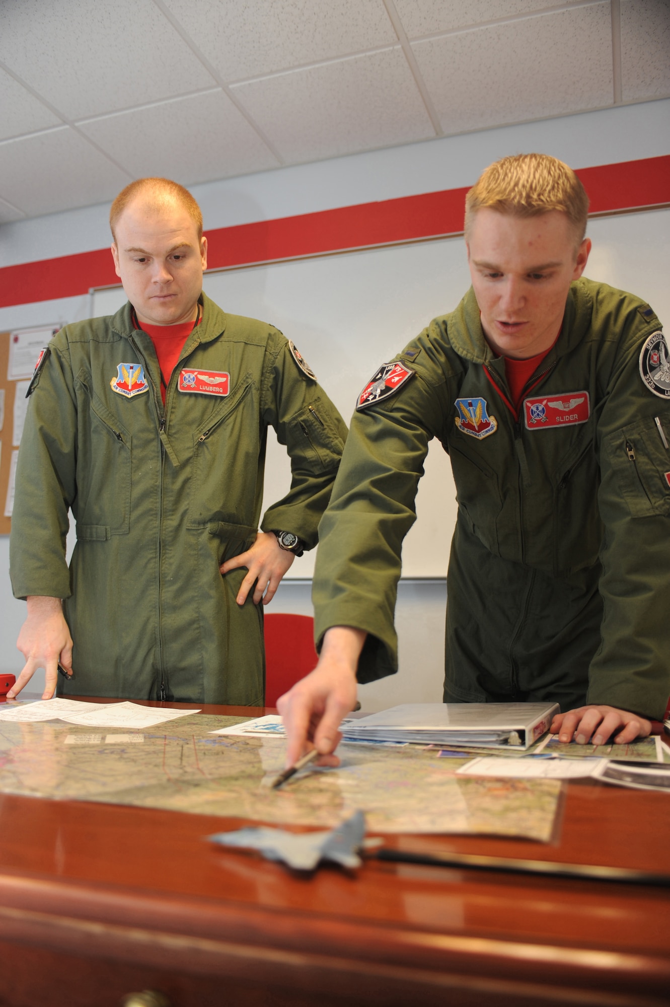 1st Lt. Clayton Couch, 333rd Fighter Squadron Basic Course student weapon systems officer, gives a low-level brief to Capt. Tom Bean, 333rd FS B-course student pilot, for their flight, at Seymour Johnson AFB, N.C., Feb. 5, 2010. The B-Course curriculum consists of academics, simulators and flight training which involve all aspects of the F-15E mission.  Bean hails from Miami, and Couch is a native of Inola, Okla.  (U.S. Air Force photo/Tech. Sgt. Lesley Waters)
