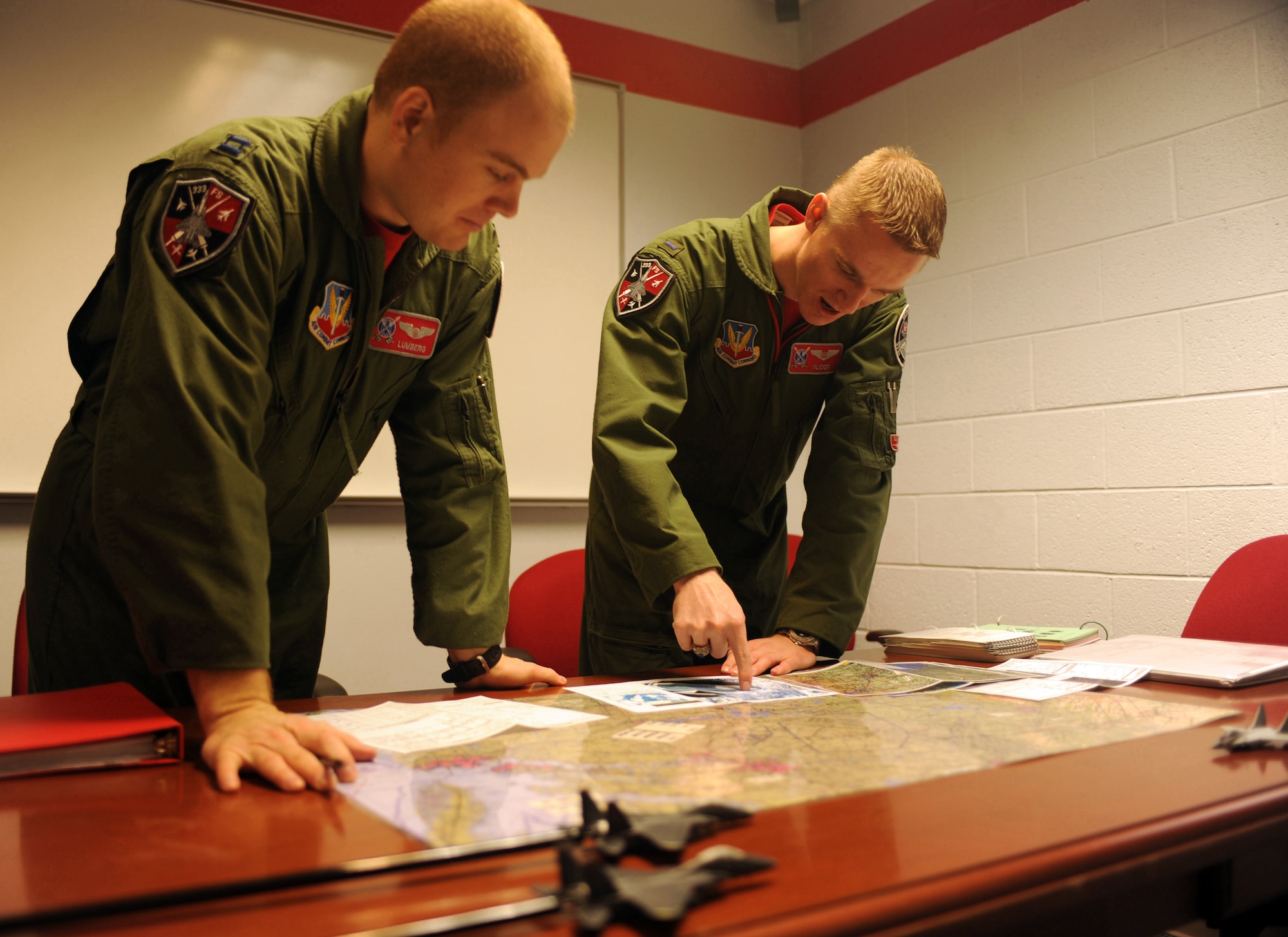 1st Lt. Clayton Couch, 333rd Fighter Squadron Basic Course student weapon systems officer, discusses a designation game plan to Capt. Tom Bean, 333rd FS B-Course student pilot, for their upcoming flight, at Seymour Johnson Air Force Base, N.C., Feb. 5, 2010. The designation game plan covers how aircrews will find and successfully attack a target. Bean hails from Miami, and Couch is a native of Inola, Okla.  (U.S. Air Force photo/Tech. Sgt. Lesley Waters)