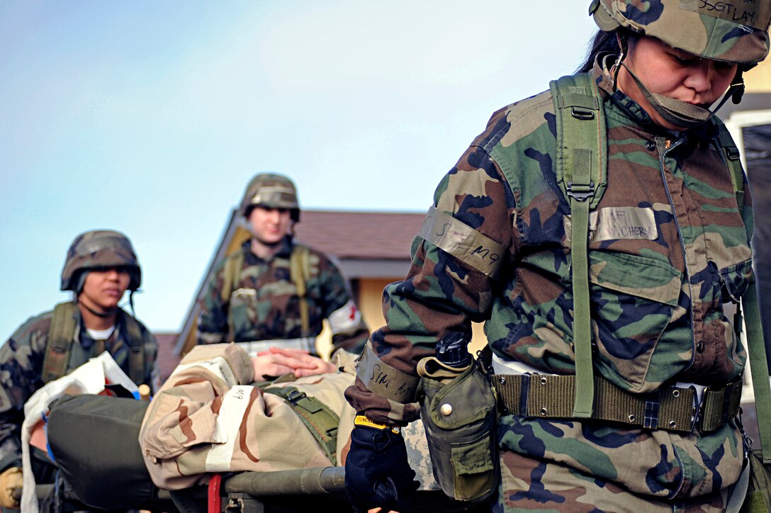 ELLSWORTH AIR FORCE BASE, S.D. -- (Right) Staff Sgt. Cheryl Lay and Tech. Sgt. Jacqueline McKenzie, 28th Medical Operations Squadron medical technicians, carry a litter to a simulated aero medical evacuation pick-up point during a Phase II Operational Readiness Exercise, March 3. The Phase II ORE tested the Airmen on a variety of deployed environment scenarios, which allowed them to utilize their combat medical skills training. (U.S. Air Force photo/Airman 1st Class Matthew Flynn)