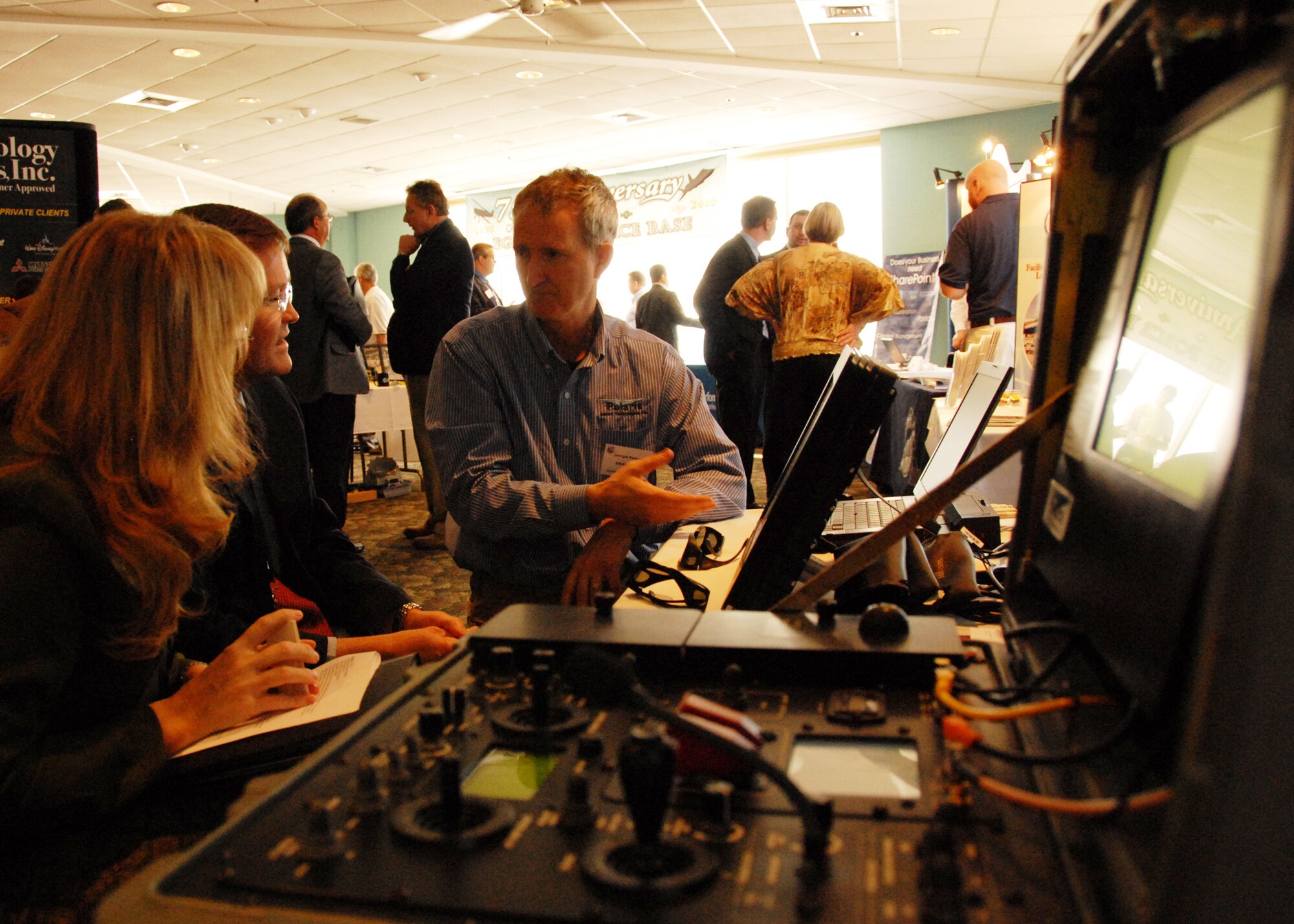(Middle) Joseph Foster, Polaris Sensor Technologies, talks to a potential client at the Small Business open house March 3 at Eglin Air Force Base, Fla.  Approximately 45 vendors turned out to exhibit their products and capabilities to government purchasers.  (U.S. Air Force photo/Samuel King Jr.)