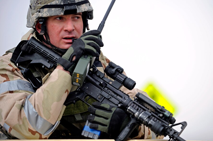 ELLSWORTH AIR FORCE BASE, S.D. -- Staff Sgt. Ben Pieta, 28th Security Forces Squadron patrolman, radios to other 28 SFS personnel after eliminating a threat at an entry control point, March 3. Sergeant Pieta is participating in a Phase II Operational Readiness Exercise that provided training and prepared Airmen for worldwide deployments. (U.S. Air Force photo/Airman 1st Class Matthew Flynn)