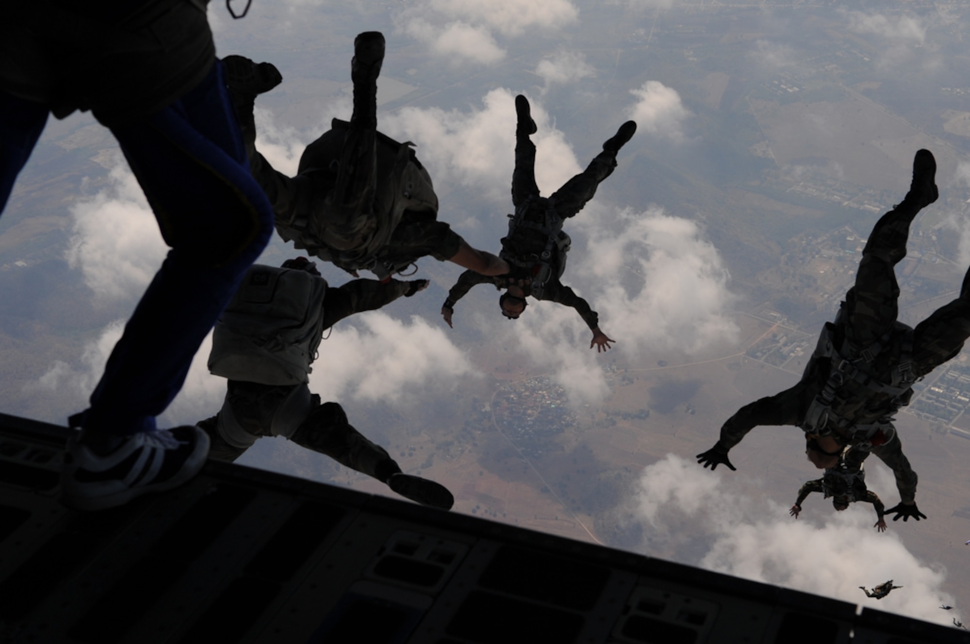 Members of the U.S. Air Force and Royal Thai Air Force Parachute Team jump from the back of a C-17 Globemaster III during Cope Tiger 2010 at Dom Muang Royal Thai Air Force Base, Thailand, March 3.  Cope Tiger is a multilateral, combined and joint command post and field training exercise involving the United States, Thailand and Singapore. The exercise takes place March 1-12. (U.S. Air Force photo/Tech. Sgt. Cohen A. Young)