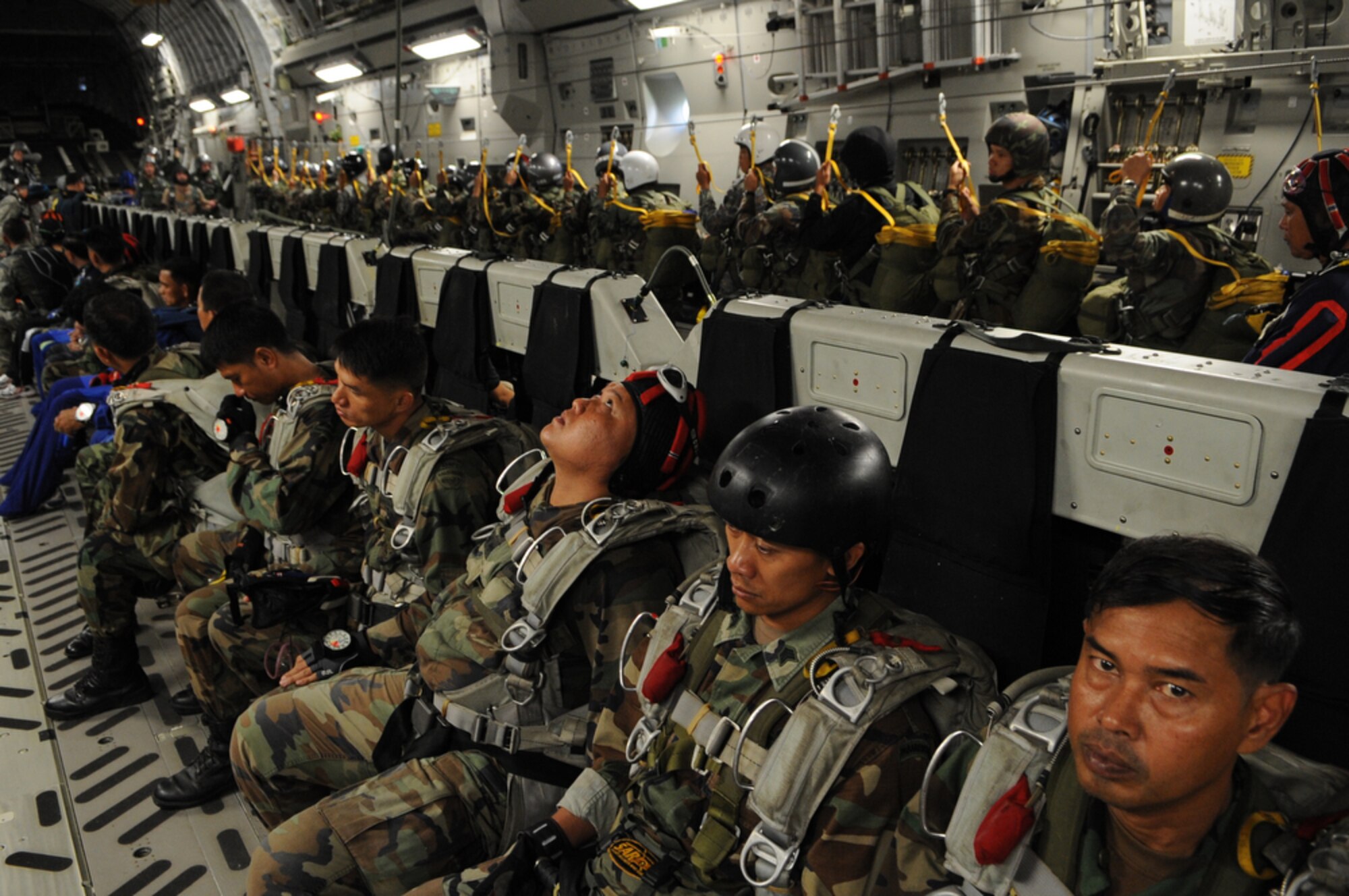 Members of the Royal Thai Air Force Parachute Team standby for a 10,000-foot static-line jump from a C-17 Globemaster III during Cope Tiger 2010 at Dom Muang Royal Thai Air Force Base, Thailand, March 3. Cope Tiger is a multilateral, combined and joint command post and field training exercise involving the United States, Thailand and Singapore. The exercise takes place March 1-12. (U.S.  Air Force photo/Tech. Sgt. Cohen A. Young)