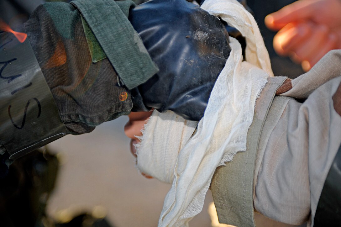 ELLSWORTH AIR FORCE BASE, S.D. -- Senior Airman Maya Baker, 28th Medical Operations Squadron medical technician, bandages the hand of a simulated chemical burn patient during a Phase II Operational Readiness Exercise, March 2. The Phase 2 ORE provided training and prepared Airmen for worldwide deployments. (U.S. Air Force photo/Airman 1st Class Matthew Flynn)