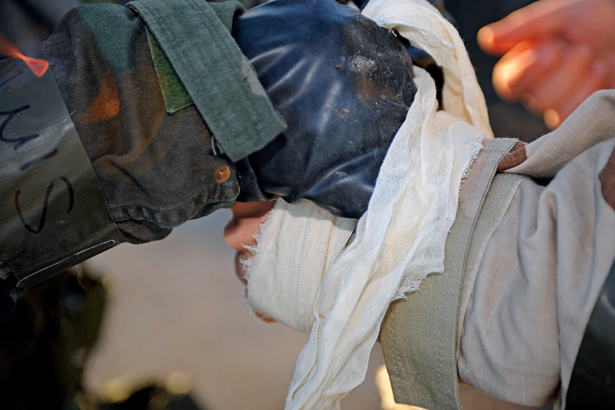 ELLSWORTH AIR FORCE BASE, S.D. -- Senior Airman Maya Baker, 28th Medical Operations Squadron medical technician, bandages the hand of a simulated chemical burn patient during a Phase II Operational Readiness Exercise, March 2. The Phase 2 ORE provided training and prepared Airmen for worldwide deployments. (U.S. Air Force photo/Airman 1st Class Matthew Flynn)
